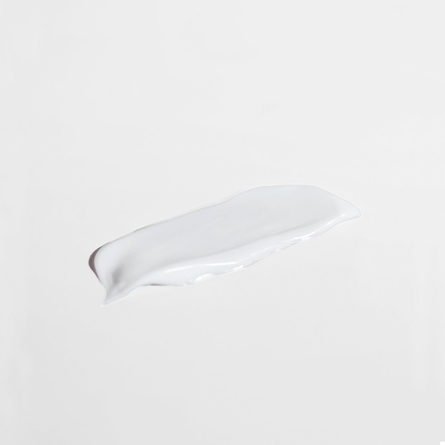 A smooth, white lotion smear of 111 & Co. ANTI AGING MOISTURIZER FOR NORMAL SKIN sits on a plain light gray background. The glossy texture and slightly uneven edges highlight its creamy consistency, designed to boost collagen and enhance skin renewal.