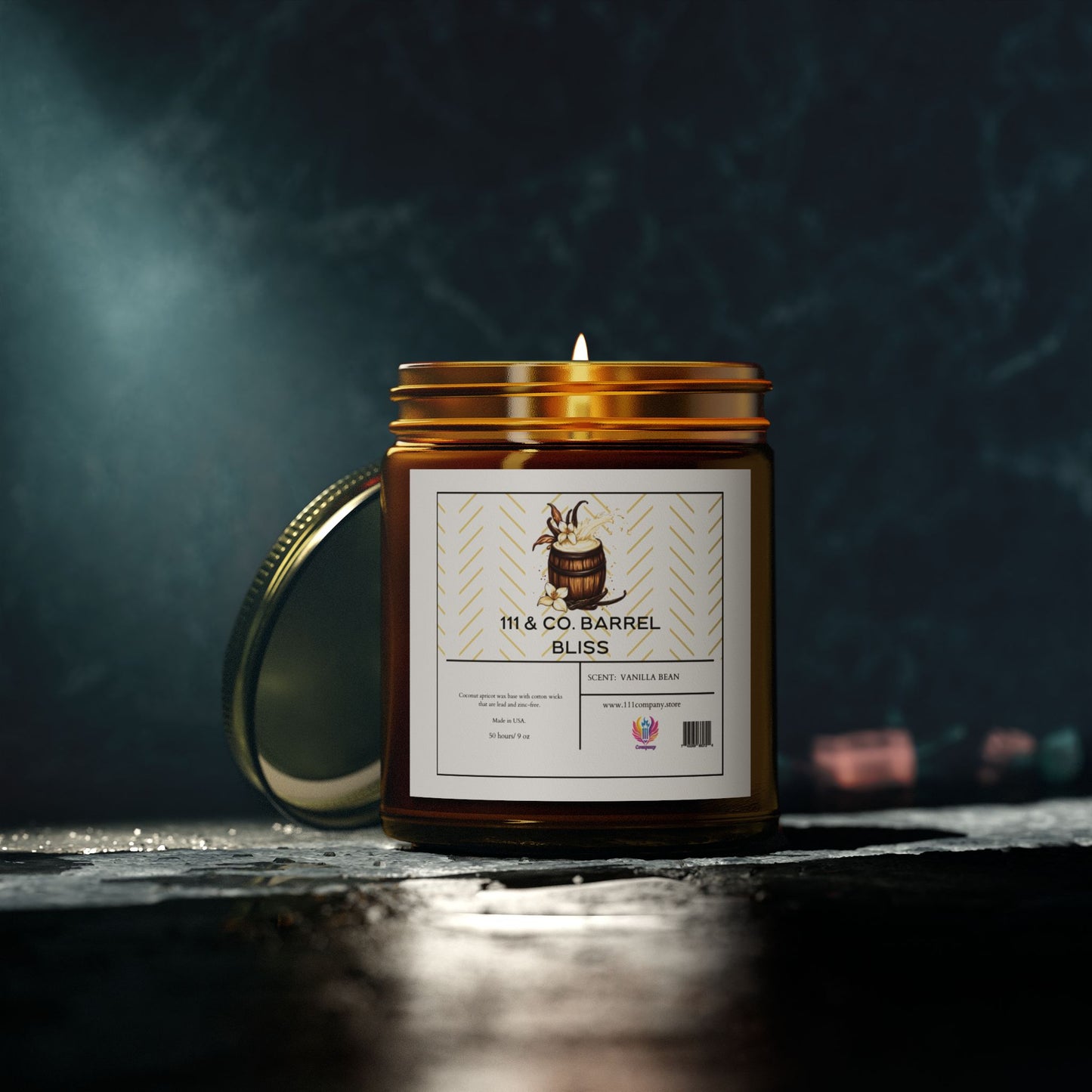 A lit 111 & COMPANY Barrel Bliss candle by 111 & Company, in an amber glass jar, rests on a dark surface. The label features a wooden barrel illustration and reads White + Vanilla Bean. The coconut apricot wax candle has its lid behind it, enhanced by soft lighting against the dark background.