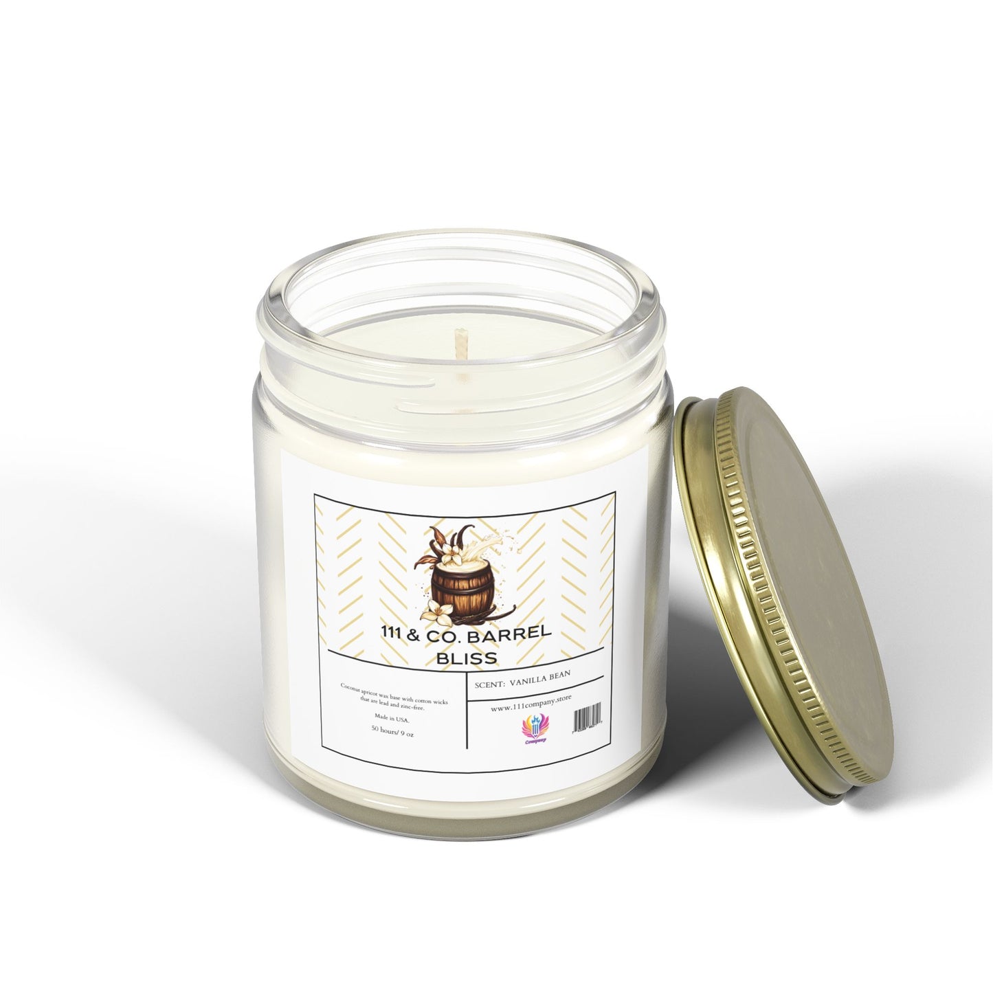 The 111 & Company Barrel Bliss candle by 111 & Company, with vanilla bean and bourbon scent in a 9oz clear jar. Made from coconut apricot wax, its wick is visible beside the gold lid on a white surface, showcasing an image of a wooden barrel and eco-friendly materials.
