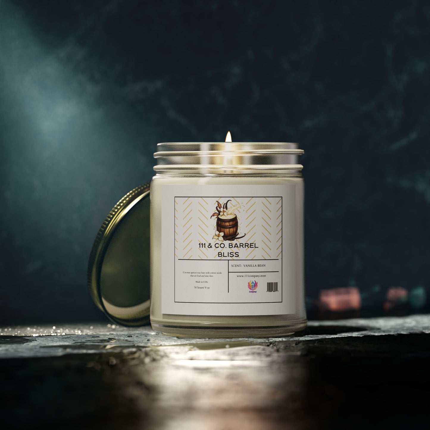 A lit 111 & Company candle in a clear jar sits beside its slightly open metal lid. The label reads 111 & Company Barrel Bliss with white vanilla bean and a barrel image. Dim lighting accentuates its bourbon fragrance against a dark, textured backdrop.
