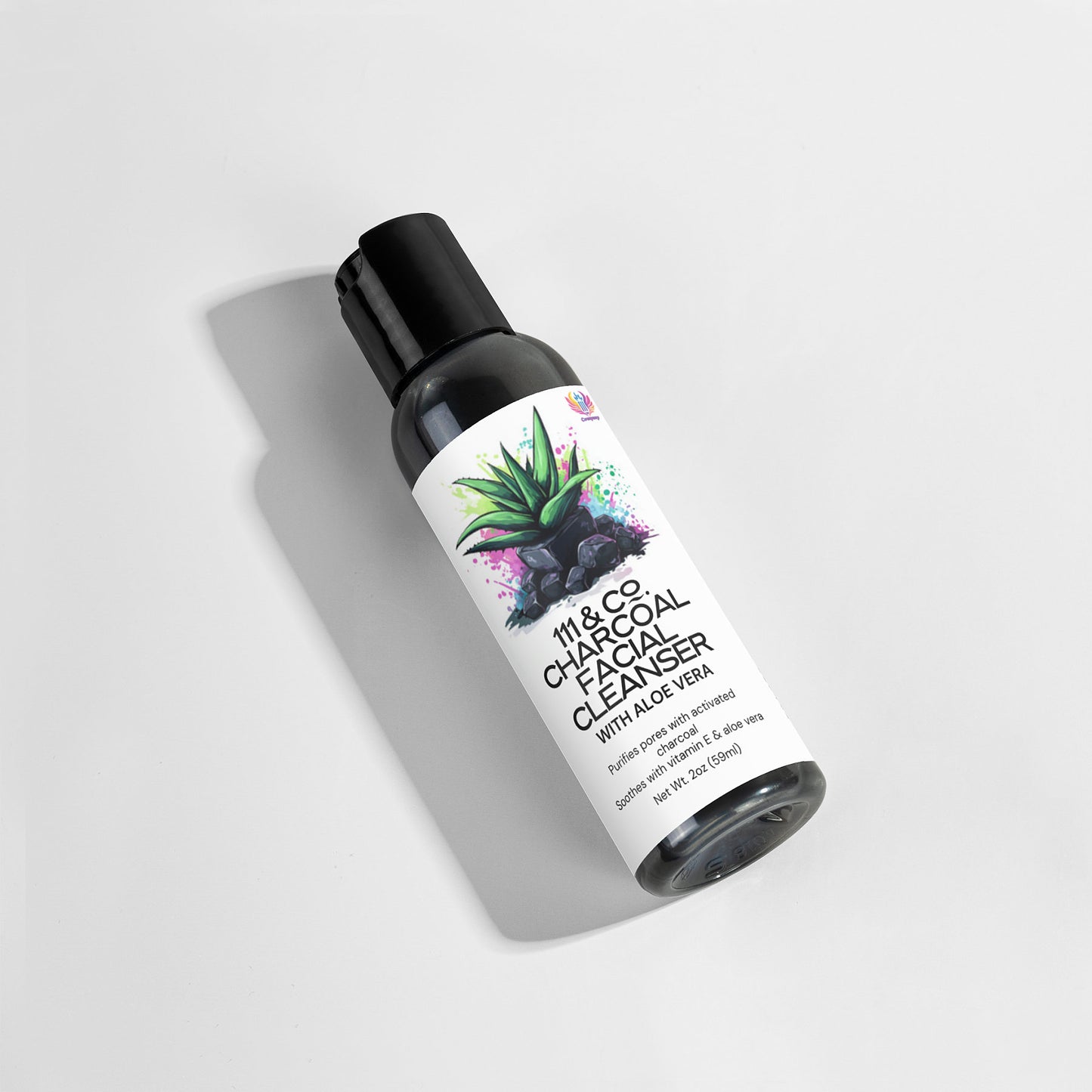 The 111 & COMPANY CHARCOAL FACIAL CLEANSER, ideal for daily use, features paraben-free ingredients like Aloe Vera. Its label design showcases an aloe illustration and dark abstract splashes, with the shadow cast left on a white background, highlighting its gray and black tones.