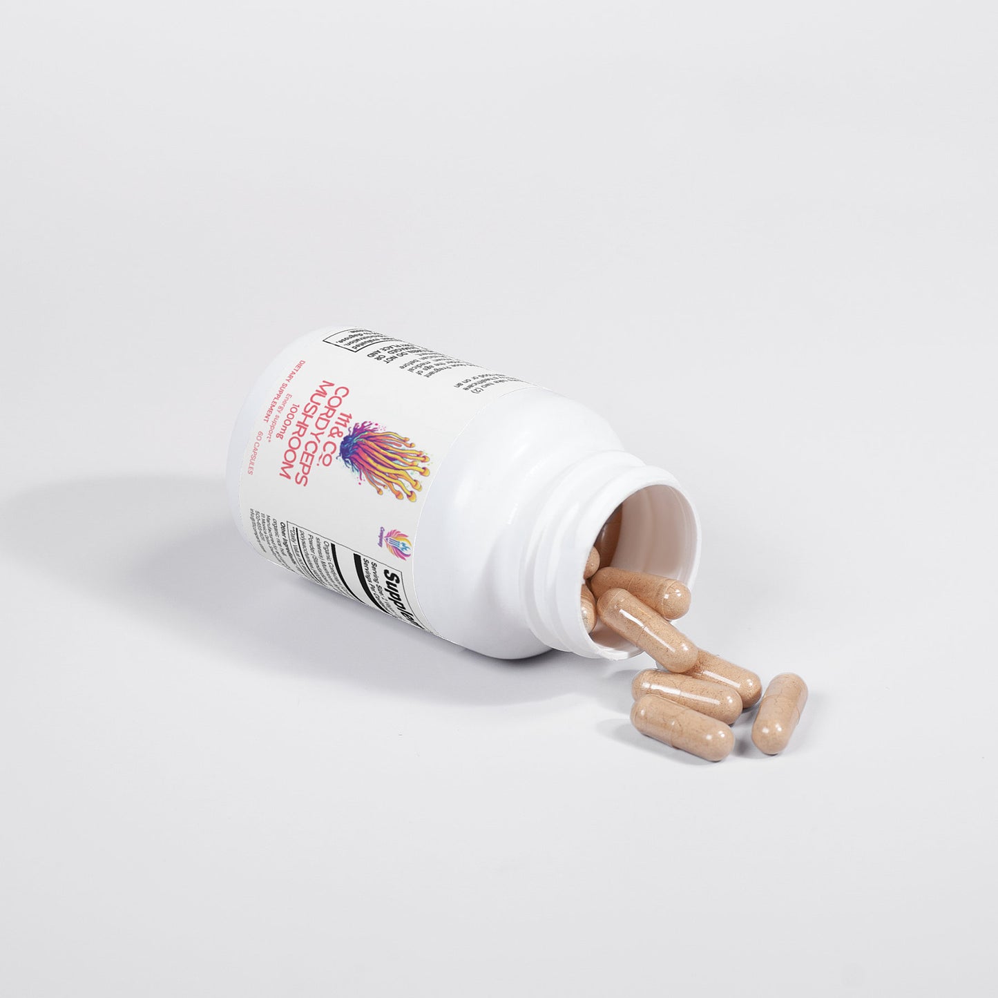 A white bottle labeled 111 & Company Cordyceps Mushroom 1000 mg Capsules lies on its side, spilling beige capsules. The label features colorful text and graphics detailing the dietary supplements benefits, highlighting its effective immune system support with Cordyceps mushrooms.