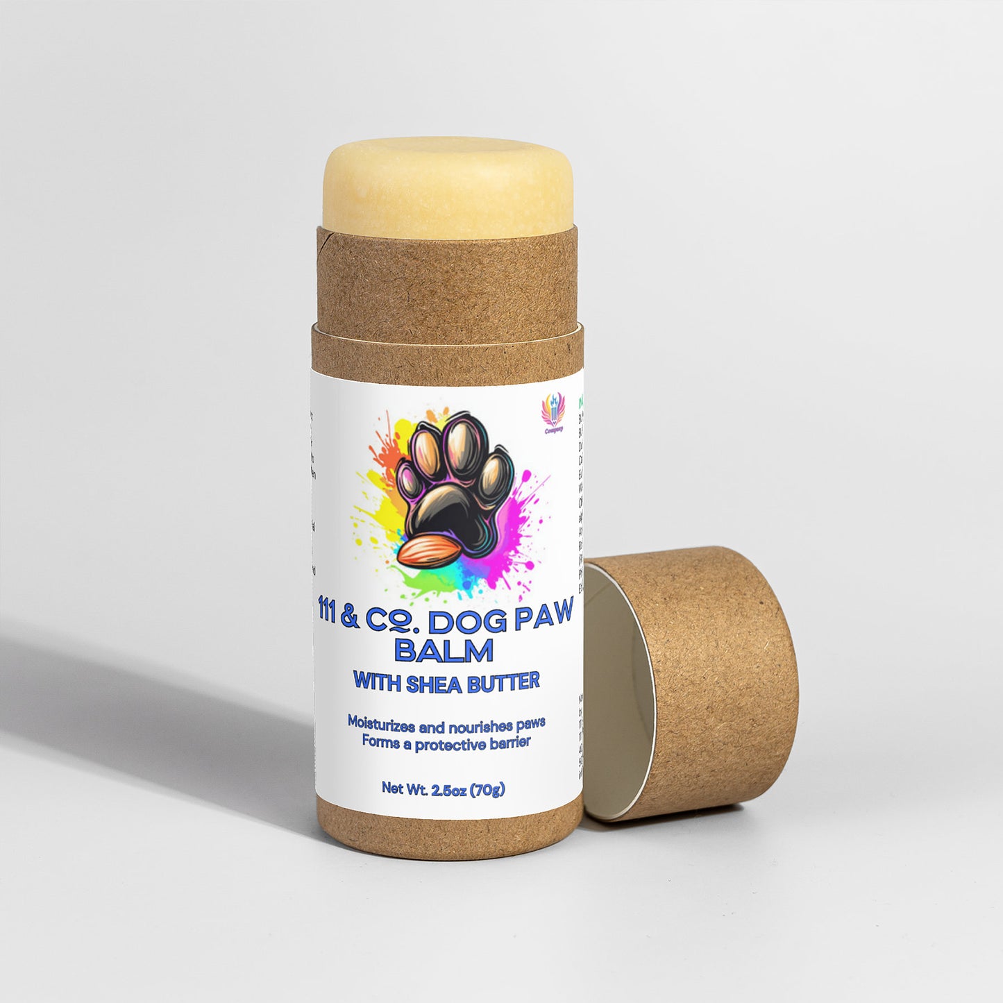A 2.5 oz (70g) tube of 111 & Company Dog Paw Balm is displayed with its cap off, showing the balm inside a biodegradable cylindrical container. The label features a colorful paw print and details about ingredients and moisturizing benefits using natural shea butter.
