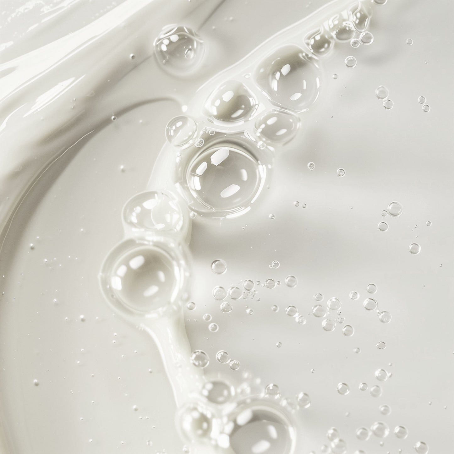A close-up of 111 & COMPANY GENTLE BALANCING TONER shows a smooth, creamy white liquid with bubbles of varying sizes on its surface. Chamomile infusion creates a glossy, slightly frothy look with dynamic light reflections enhancing the fluids texture and movement.
