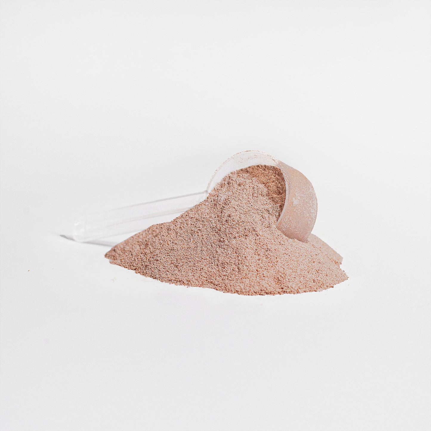 A clear plastic scoop of 111 & Company Grass-Fed Collagen Peptides Powder (Chocolate) is tipped over on a white surface, with some powder spilled in front, forming a small pile. The entirely white background emphasizes the texture and color of this rejuvenating supplement.