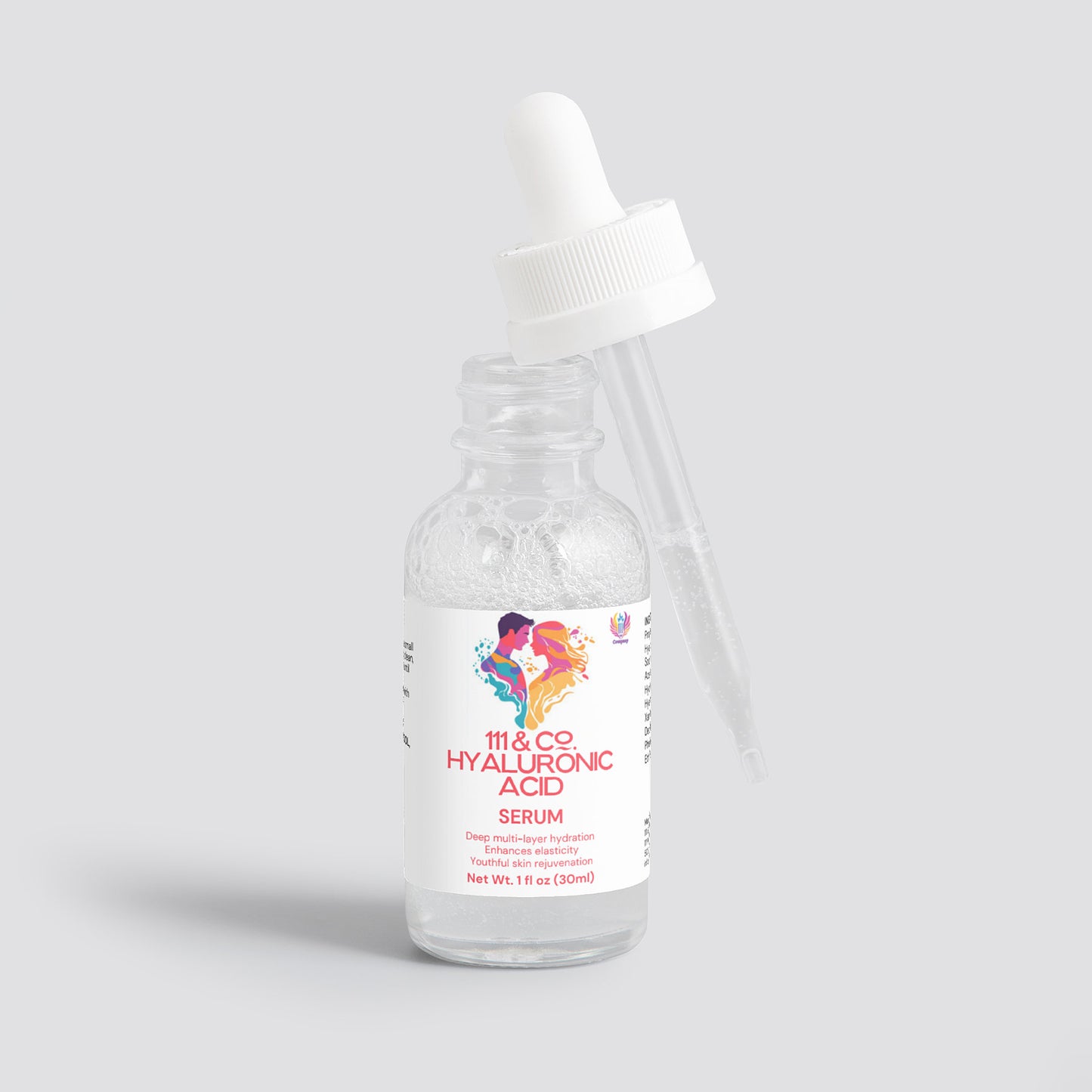 A clear glass bottle of 111 & COMPANY HYALURONIC ACID SERUM from 111 & Company with a dropper rests against it, offering hydration and skin rejuvenation. The cap is off, the dropper partially filled. The label displays colorful abstract art and product details against a light gray background.