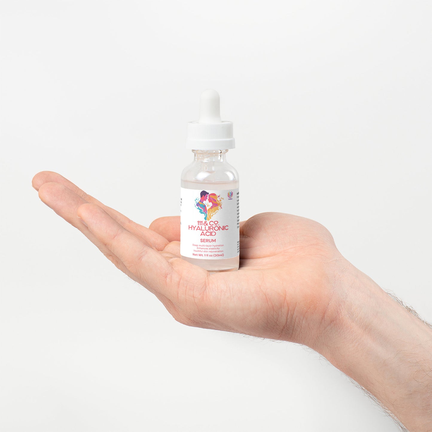 A hand holds a small glass bottle of 111 & COMPANY HYALURONIC ACID SERUM, ideal for hydration and skin rejuvenation. The bottle features a white dropper cap and a vibrant label with colorful graphics and red text on a plain white background.