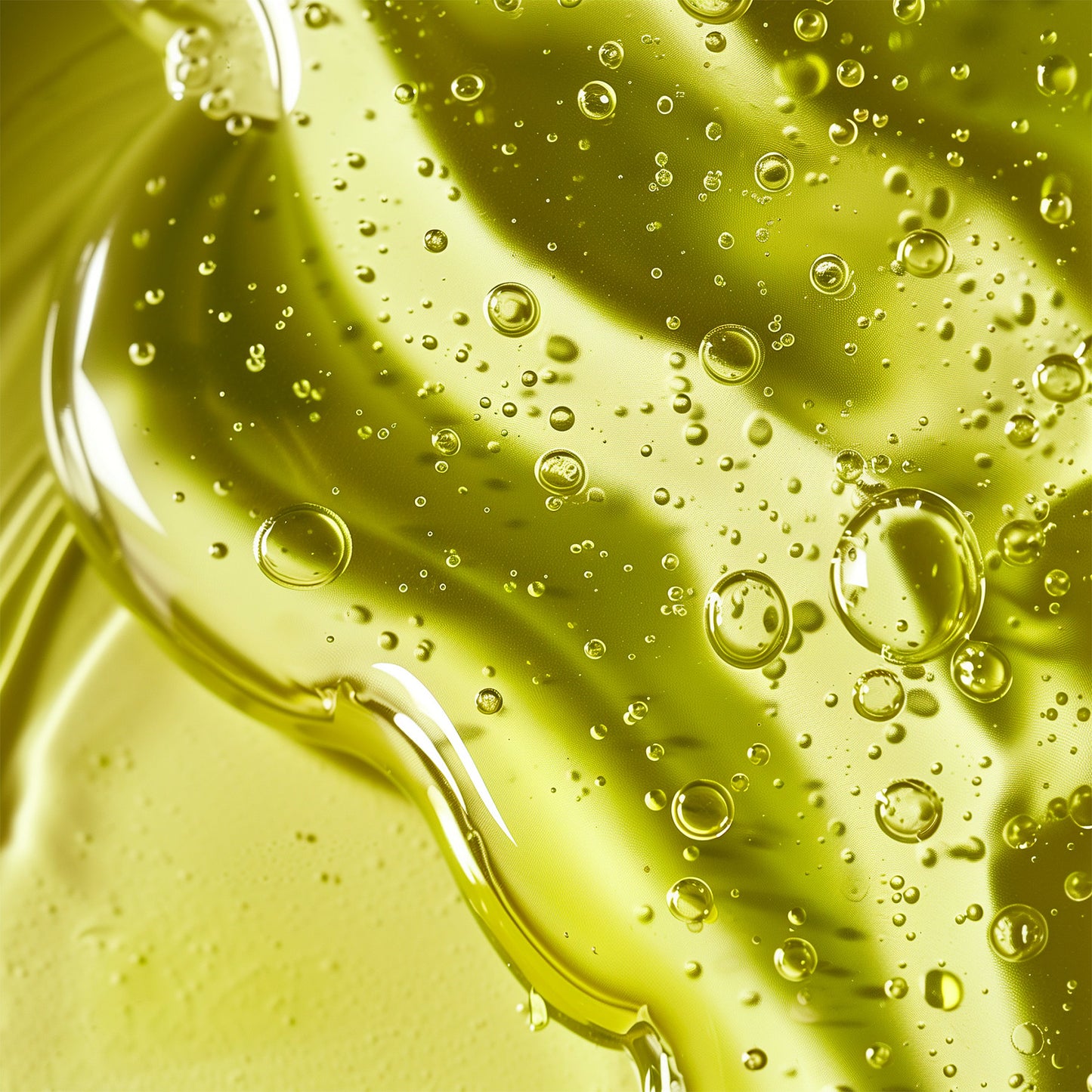 Close-up of the 111 & COMPANY Hydro Balancing Gel-Cream by 111 & Company shows greenish-yellow fluid with trapped air bubbles. Its translucent nature refracts light, creating highlights and shadows. Bubbles vary in size, adding a dynamic look that complements its hydrating benefits for oily skin.