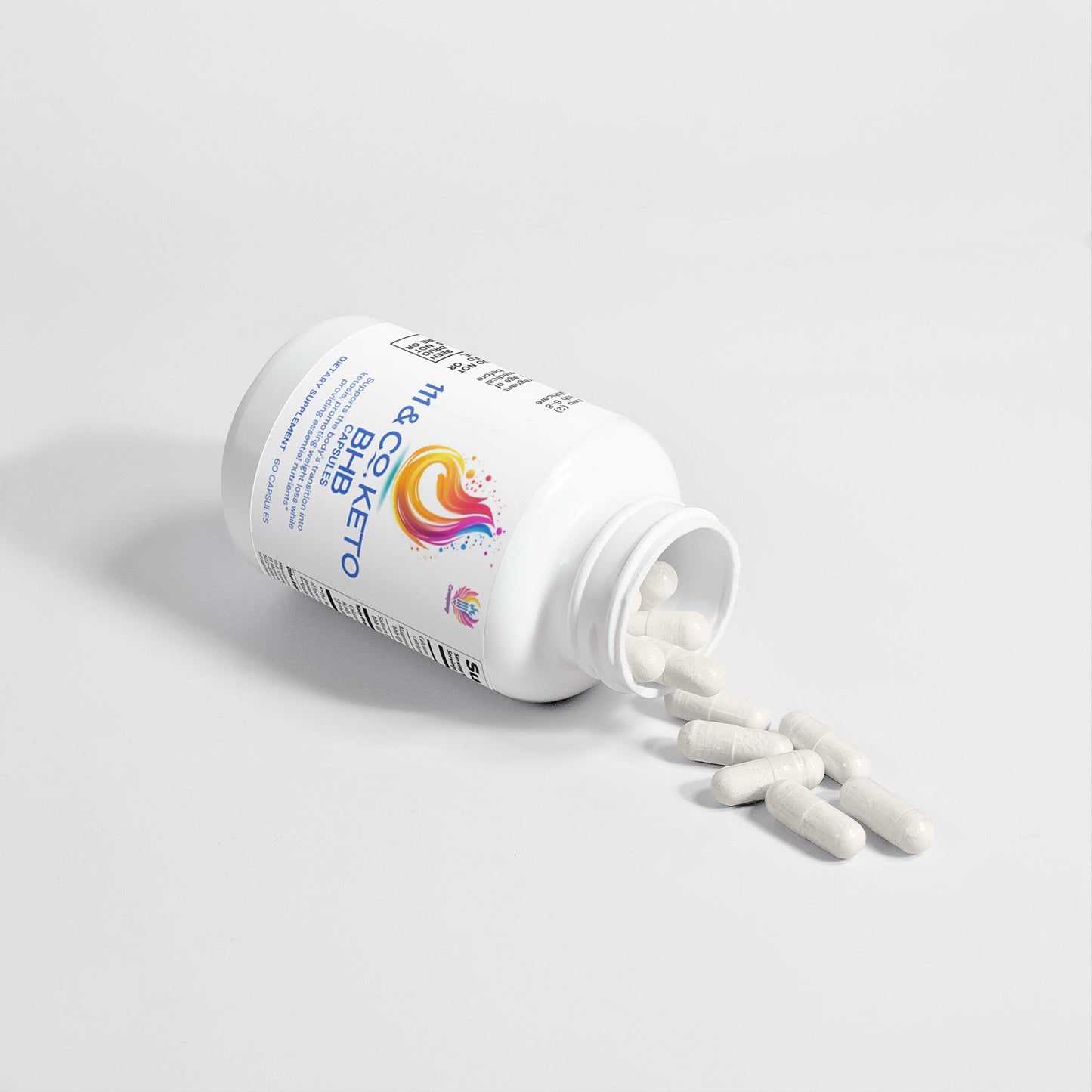 A white bottle labeled 111 & Company Keto BHB lies on its side with several white capsules spilling out. Featuring a colorful swirl design and nutritional info, this 111 & Company aids in a smooth ketosis transition. The bottle rests on a plain, light gray surface.