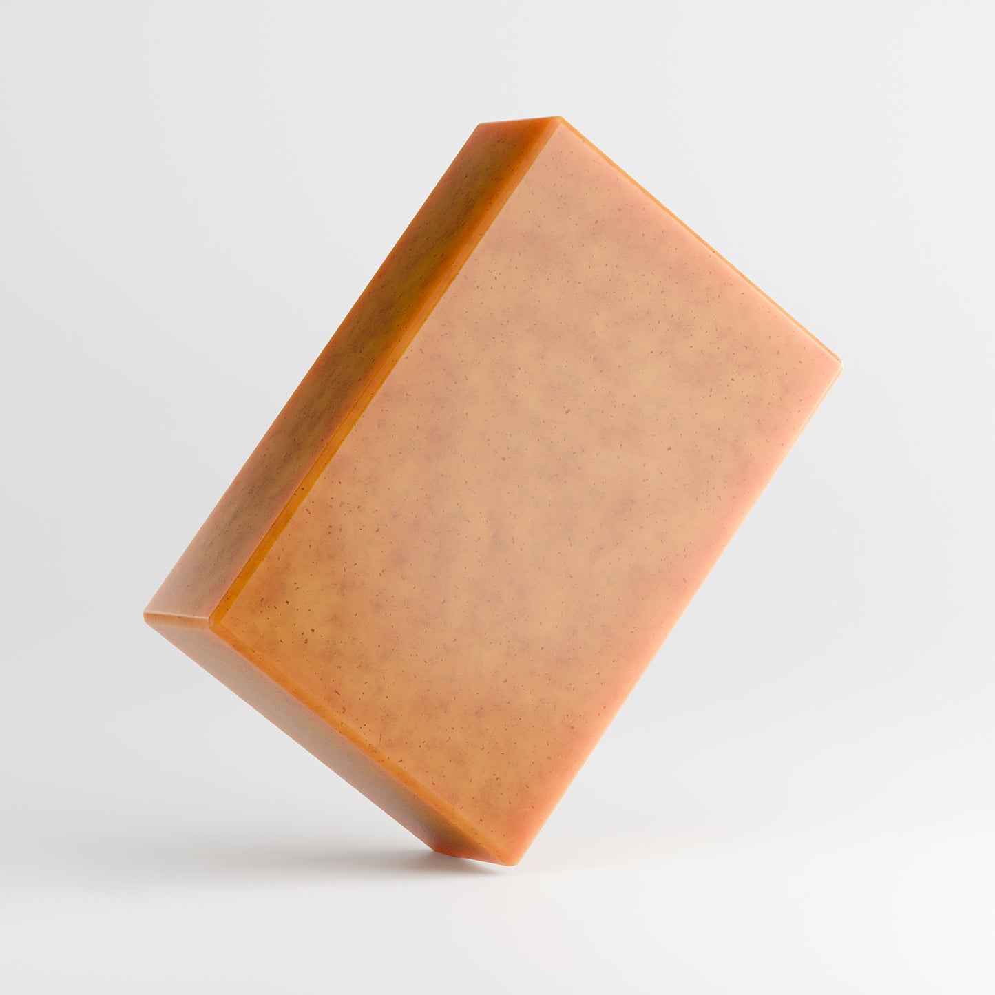 The 111 & COMPANY KOJIC ACID & TURMERIC SOAP by 111 & Company is a caramel-hued, rectangular bar with tiny dark speckles. Angled against a light gray background, it features smooth surfaces and sharp edges, offering a brightening formula for a radiant glow.