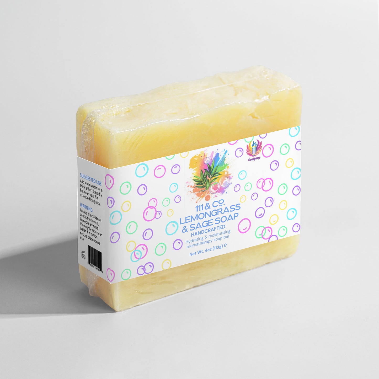 Yellow-hued handmade soap bar, wrapped with a white label adorned with colorful bubbles. The label reads 111 & Company Lemongrass & Sage Soap by 111 & Company, enriched with organic oils and lemongrass and sage illustrations. Ideal for sensitive skin, net weight 4oz (113g), on a light gray backdrop.