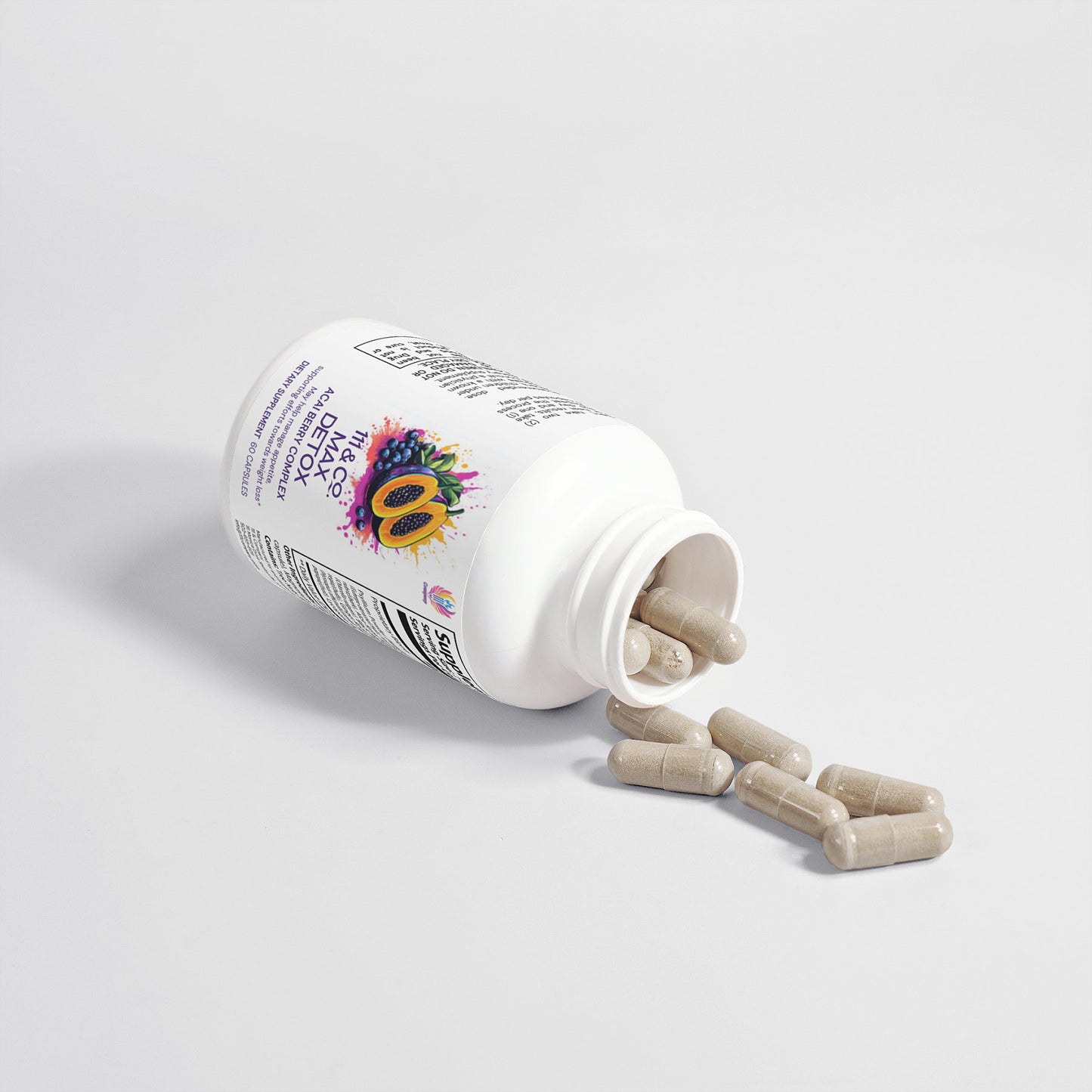 A white bottle labeled 111 & Company Max Detox (Acai Detox) Capsules with colorful graphics lies tipped over on a white surface. Light brown capsules made with natural ingredients spill from the open lid, scattering in front of the 111 & Company bottle and casting subtle shadows.