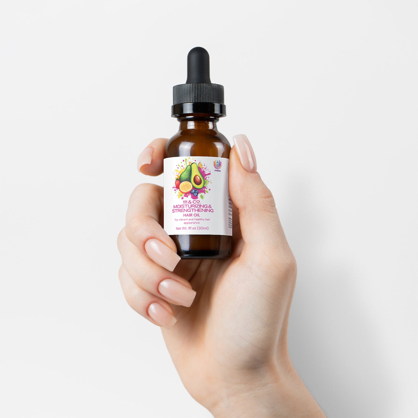 A manicured hand holds a small amber bottle from 111 & Company with a dropper lid, hinting at its use as nourishing hair oil. The label features an avocado illustration and the product name 111 & COMPANY MOISTURIZING AND STRENGTHENING HAIR OIL, highlighted against a plain white background.