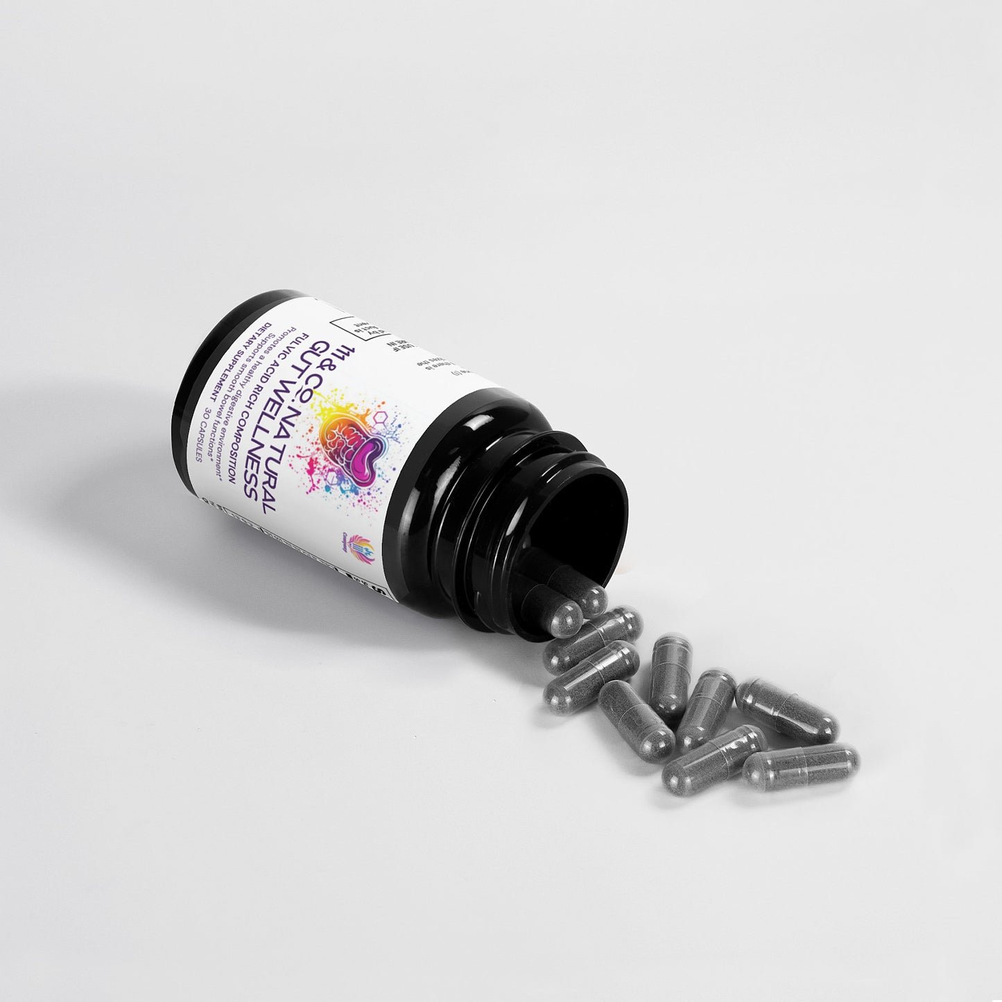 A dark bottle labeled 111 & COMPANY NATURAL GUT WELLNESS CAPSULES by 111 & Company is tipped over on a white surface, spilling gray capsules. The label features colorful graphics and text, highlighted under bright lighting to showcase the capsules and contents.