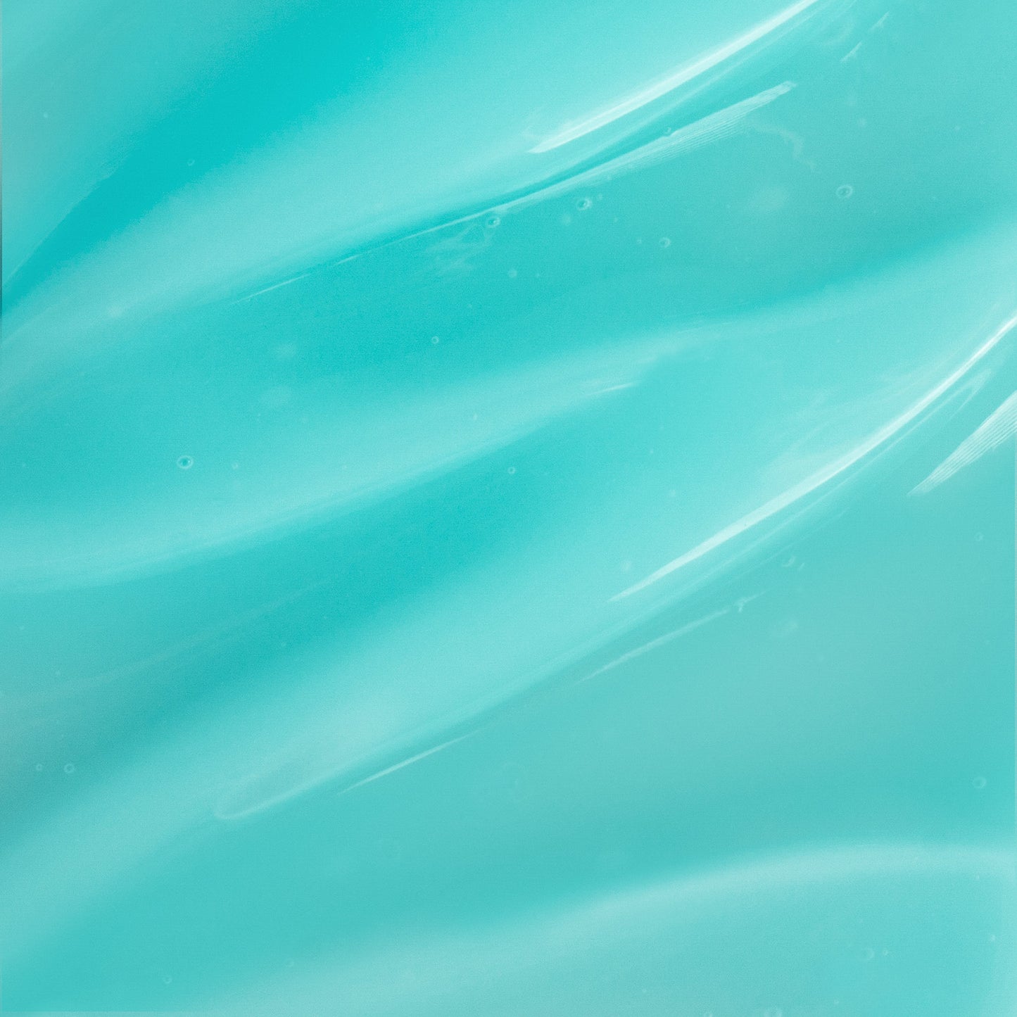 A close-up view of a smooth, glossy teal surface featuring wavy patterns reflects the cooling effect of 111 & COMPANY POLAR FLEX COOLING GEL. The soft, fluid texture with highlights, shadows, and small bubbles adds depth and visual interest to the undulating design.