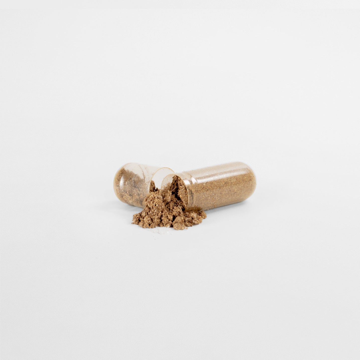 On a white background, an open transparent capsule of 111 & COMPANY PROSTATE SUPPORT by 111 & Company spills brown powder from one half. The horizontal halves exhibit the powdery substance inside, highlighting natural ingredients for mens wellness.