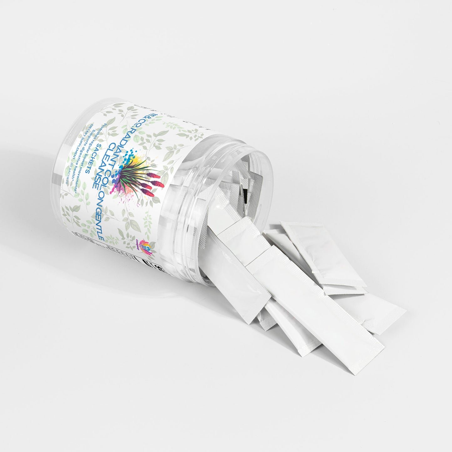 A clear plastic jar from 111 & Company lies on its side, spilling several 111 & Co. RADIANT COLON GENTLE CLEANSE SACHETS onto a white surface. The label features herbal illustrations and text about colon health, with each silver packet showcasing an individual serving for optimal digestive wellness.