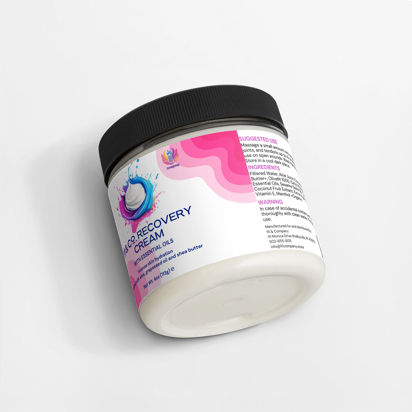 A jar of 111 & COMPANY RECOVERY CREAM by 111 & Company, with a black lid, lies on its side. The label displays pink waves and a splash graphic, highlighting essential oils for skin hydration. Ingredients and directions are listed. The jar rests elegantly on a white surface.