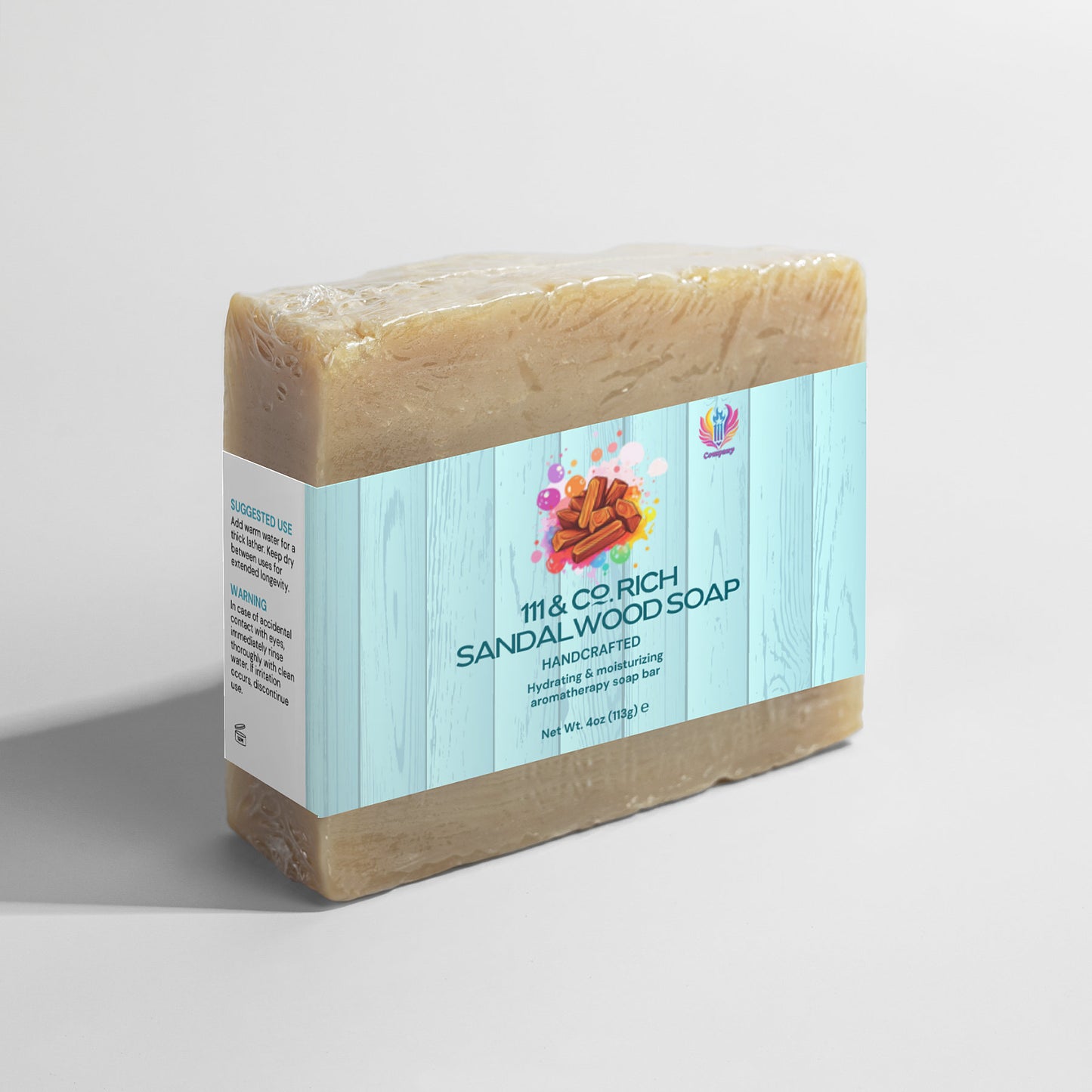 The 111 & COMPANY RICH SANDALWOOD SOAP by 111 & Company is a 4oz (113g) rectangular bar wrapped in white with a blue stripe. Featuring sandalwood stick illustrations, it casts shadows on a light gray background and is ideal for sensitive skin.