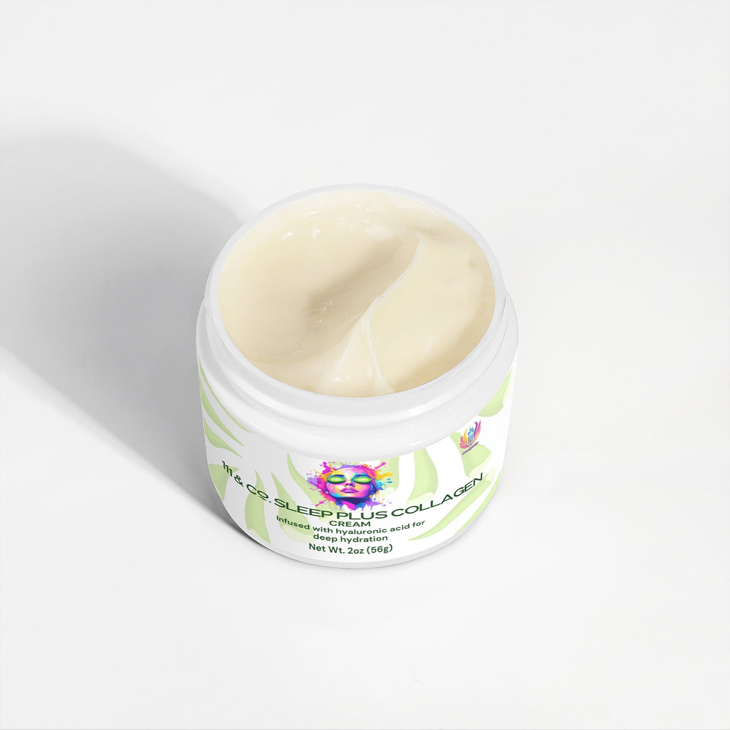 An open jar of hydrating collagen cream with a light beige color and smooth texture, labeled 111 & COMPANY SLEEP PLUS COLLAGEN CREAM. The white label features abstract green leaves, and the packaging includes colorful artwork of a face by 111 & Company—ideal for your skincare routine.