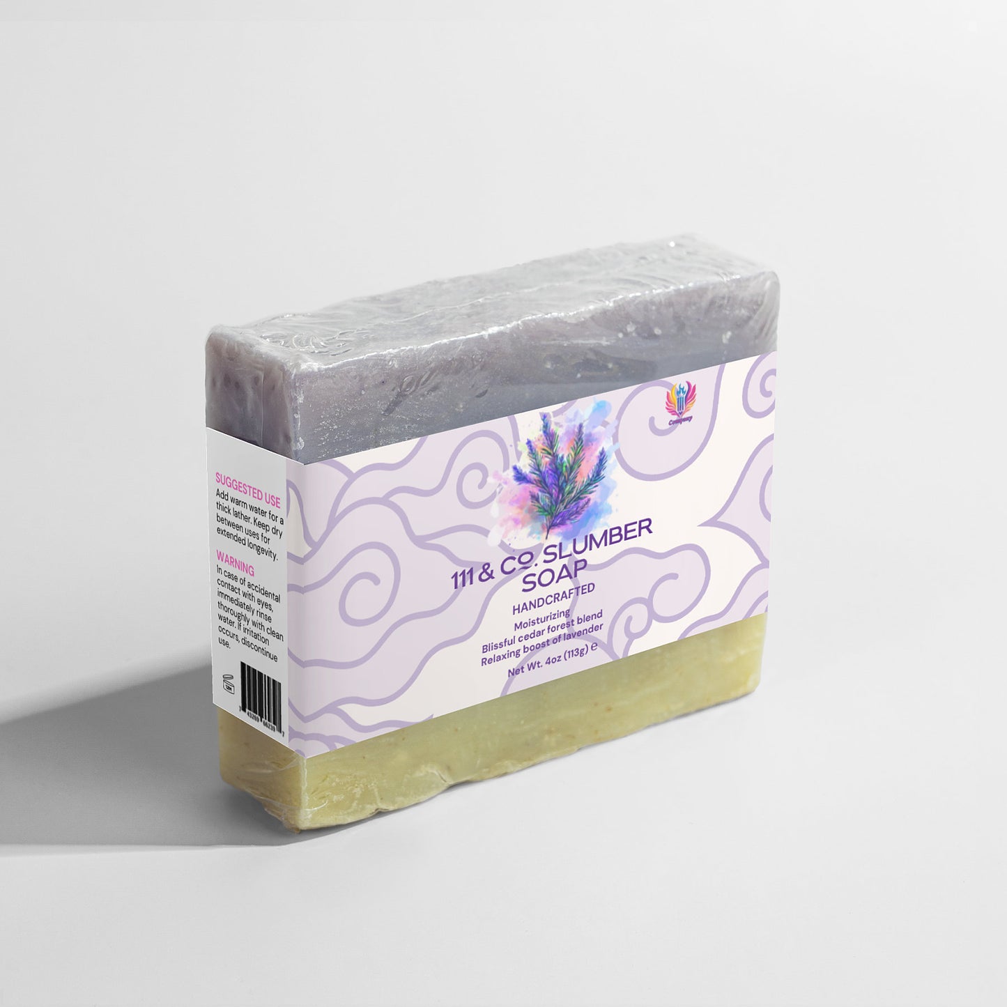 The handcrafted bar of 111 & COMPANY SLUMBER SOAP by 111 & Company is wrapped in clear plastic, showcasing purple and cream hues. Its label highlights lavender and fir needle artwork, with usage tips and ingredients on a white background accented by purple swirls.