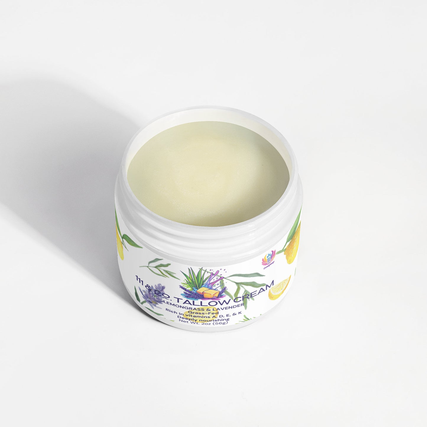 An open jar of 111 & COMPANY Tallow Cream Lemongrass & Lavender by 111 & Company sits on a white surface, its pale cream promising soothing hydration for sensitive skin, with botanicals on the label reflecting its gentle formula.