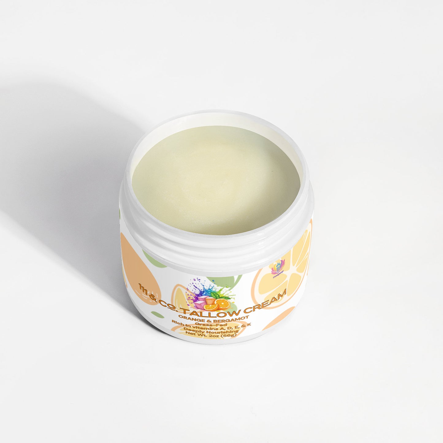 An open jar of 111 & COMPANY TALLOW CREAM ORANGE & BERGAMOT by 111 & Company sits on a white background, revealing its smooth texture. The floral label highlights Grass-Fed Beef Tallow Cream with nourishing fat-soluble vitamins, elegantly accented in orange and lavender.