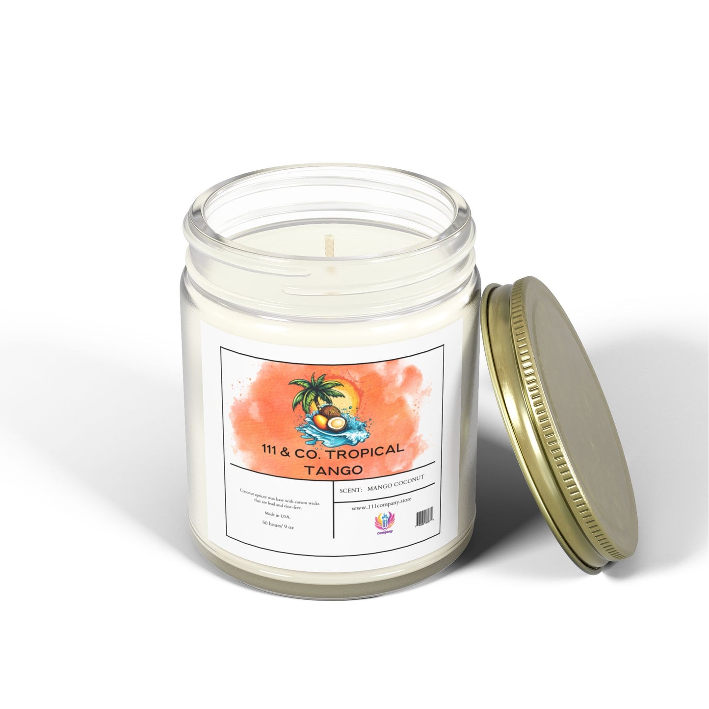 Beside it is a clear glass jar candle with a gold lid from 111 & Company, featuring a tropical palm tree and fruit scene on the label. It reads 111 & Co. Tropical Tango and Scent: Coconut Mango Candle. Made with eco-friendly coconut apricot wax for an island escape, 9 oz.