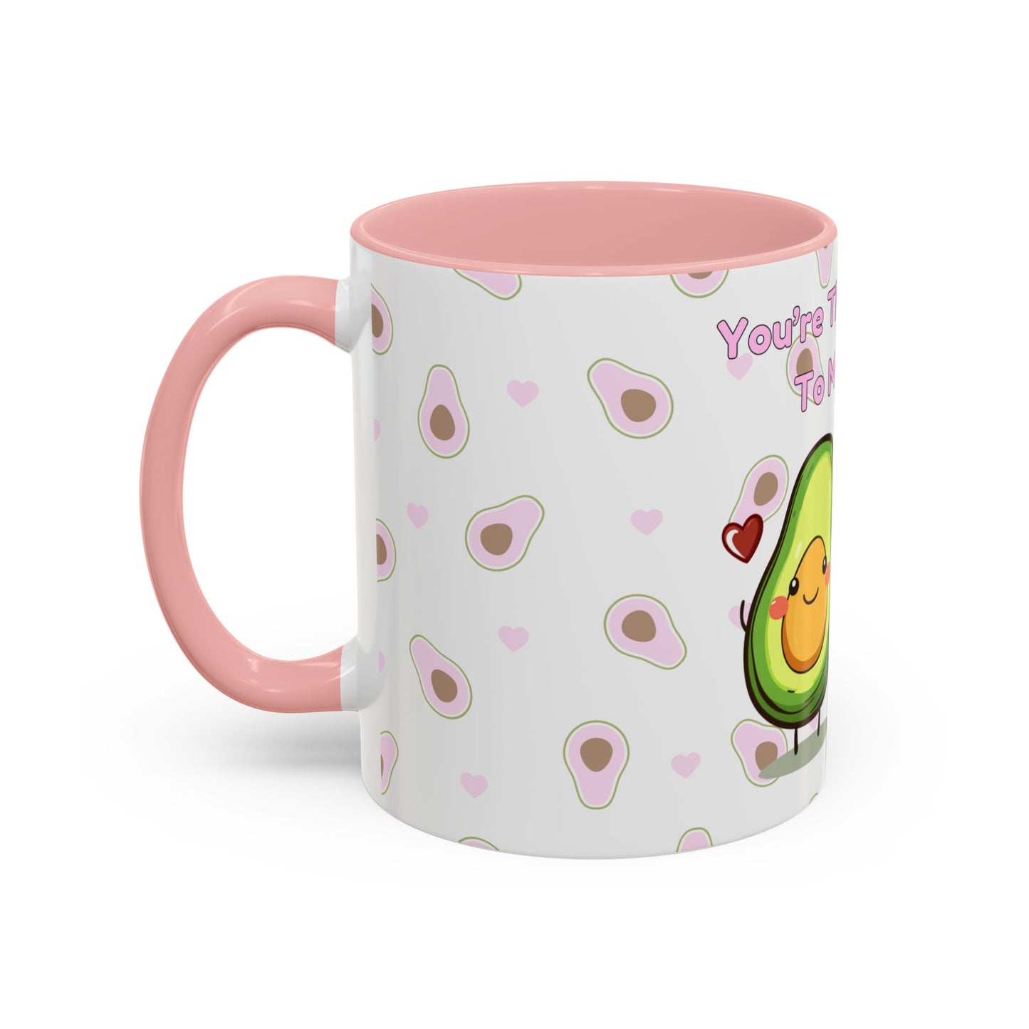 The 111 & COMPANY Valentines Avocado Toast Coffee Mug by 111 & Company, ideal for avocado enthusiasts, features a vibrant design with a white base and pink handle. A smiling avocado with a red heart is surrounded by pink hearts and slices, with the text You're... partially visible.