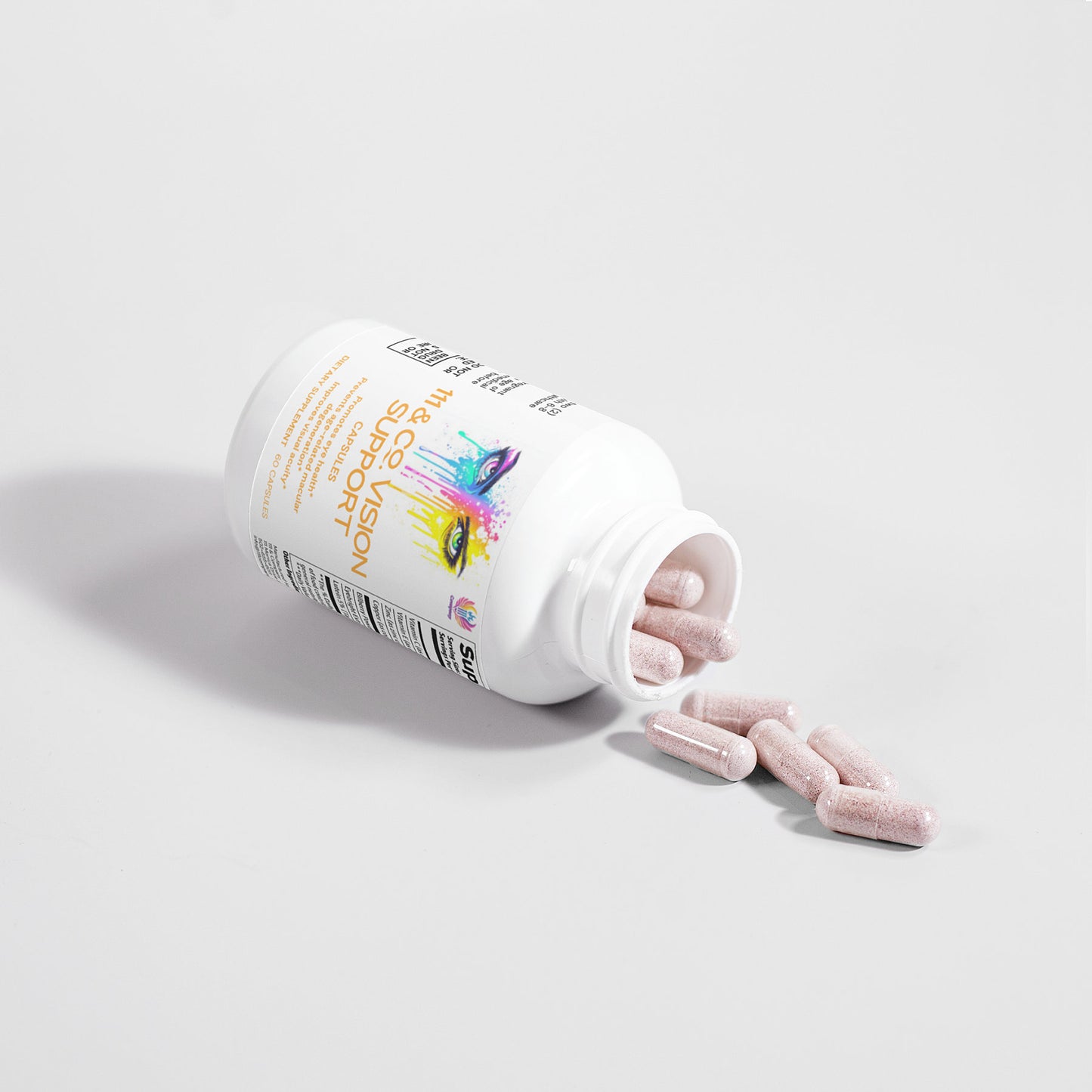 A white bottle labeled 111 & COMPANY VISION SUPPORT CAPSULES from 111 & Company is on its side, spilling pink capsules onto a white surface. The colorful label emphasizes antioxidants for eye health, while the oblong speckled capsules cast shadows below.