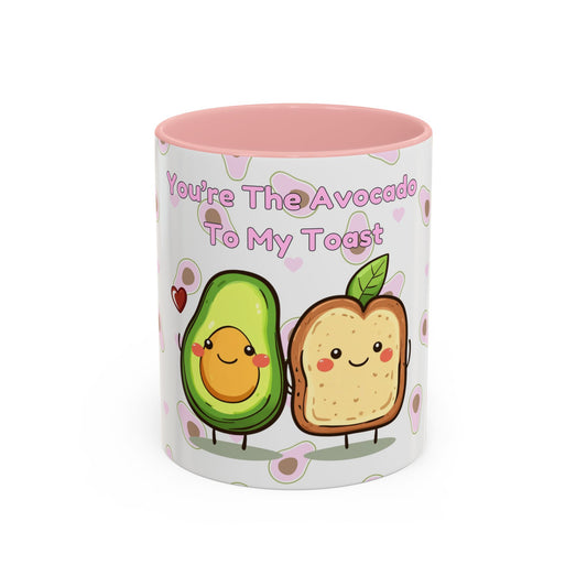 The 11 oz Printify 111 & COMPANY Valentines Avocado Toast Coffee Mug is perfect for avocado fans, featuring a cheerful avocado half and toast with smiling faces, captioned Youre the Avocado to My Toast, set against a backdrop of small hearts and avocado patterns.