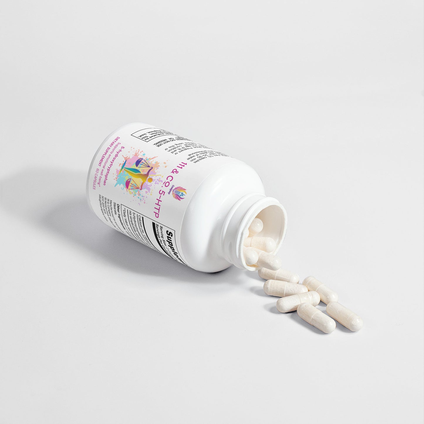 A white 111 & Co. 5-HTP bottle by 111 & Company lies sideways, spilling white capsules onto a light gray surface. Adorned with colorful graphics promoting emotional well-being, its cap is off and more capsules are visible inside. The setting is simple and softly lit.