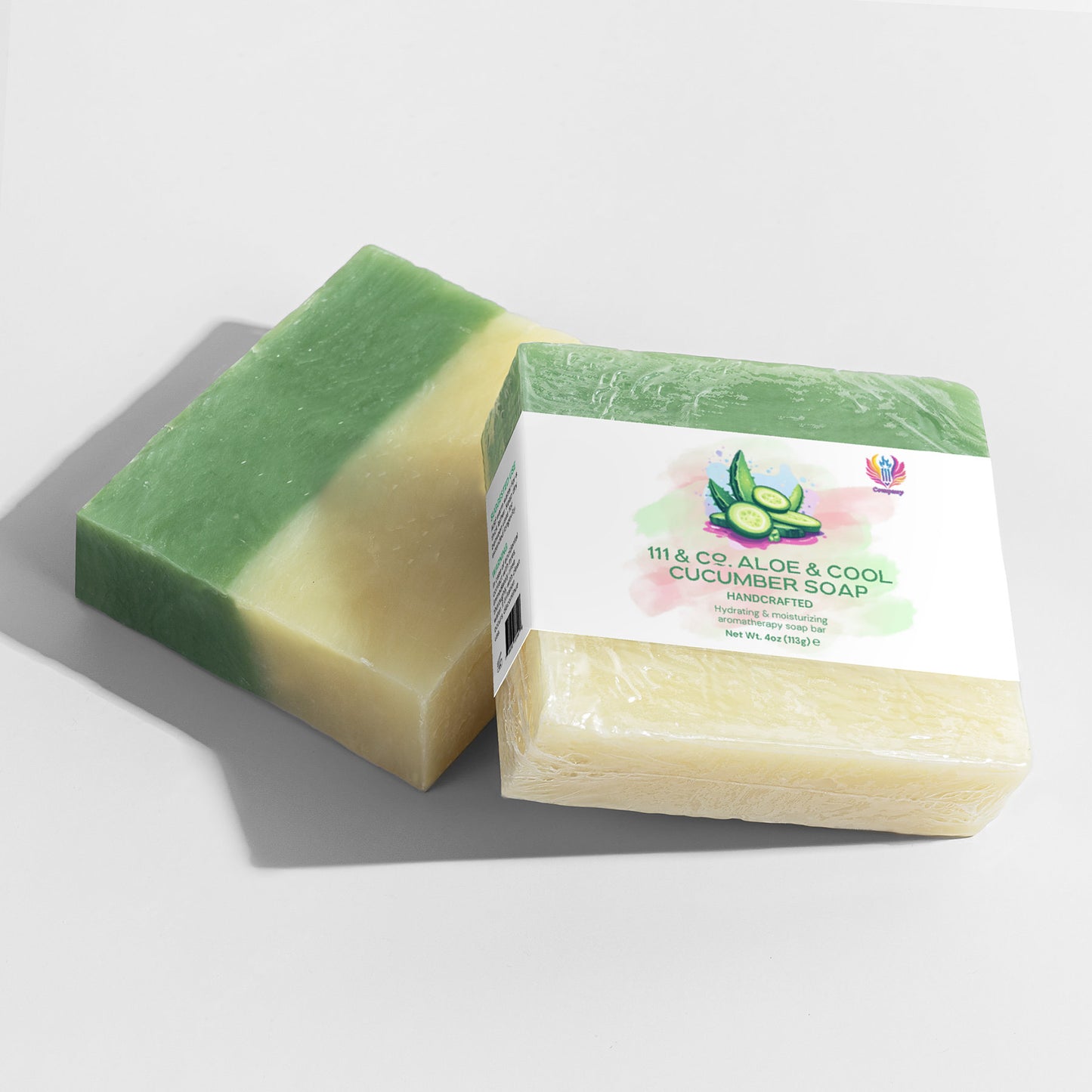 Two handcrafted soaps are shown. One is green and cream; the other is wrapped in clear plastic with a 111 & Co. ALOE & COOL CUCUMBER SOAP label from 111 & Company, highlighting hydrating benefits for sensitive skin with aloe and cucumber graphics on a grey background.