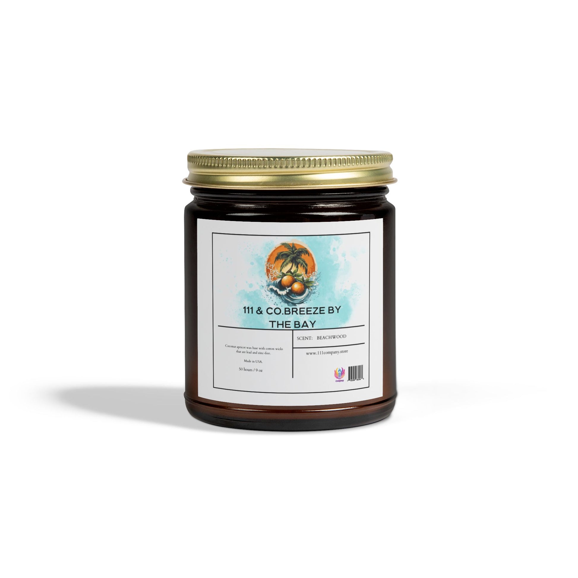 The amber glass candle from 111 & Company, labeled 111 & Co. Breeze by the Bay Beachwood, is set against a white backdrop. Its eco-friendly appeal is highlighted by 100% Coconut Apricot Wax, with palm trees and a sunset image conveying its Beachwood scent.