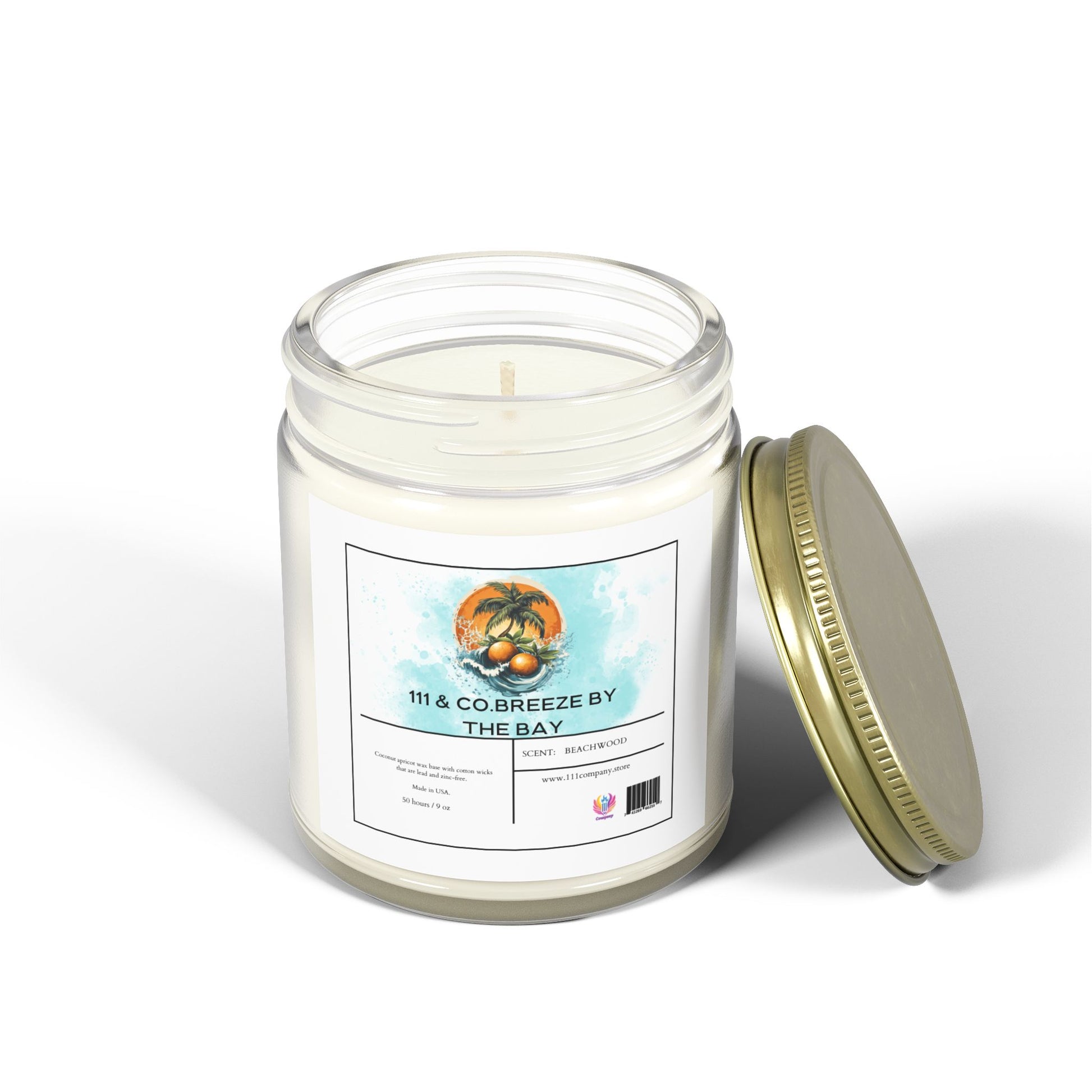 The 111 & Company Breeze by the Bay Beachwood Scented Candle is a 9oz clear jar with coconut apricot wax. Its tropical design includes palm trees and sunsets, offering a beachy driftwood fragrance and featuring white wax with a single wick for an eco-friendly coastal escape.