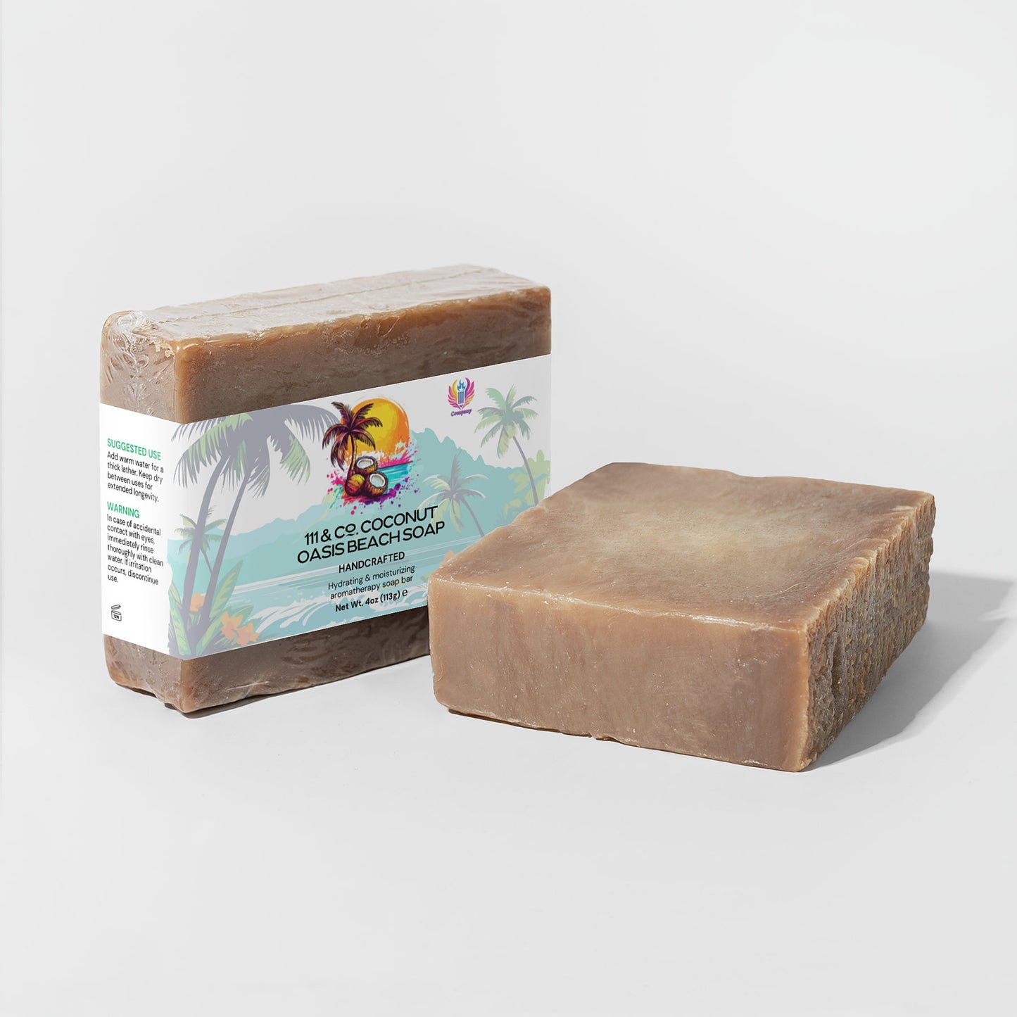 Against a plain background, two soap bars are displayed: one wrapped with tropical imagery labeled 111 & COMPANY COCONUT OASIS BEACH SOAP, ideal for sensitive skin, and the other unwrapped showcasing its smooth brown surface enriched with organic oils.