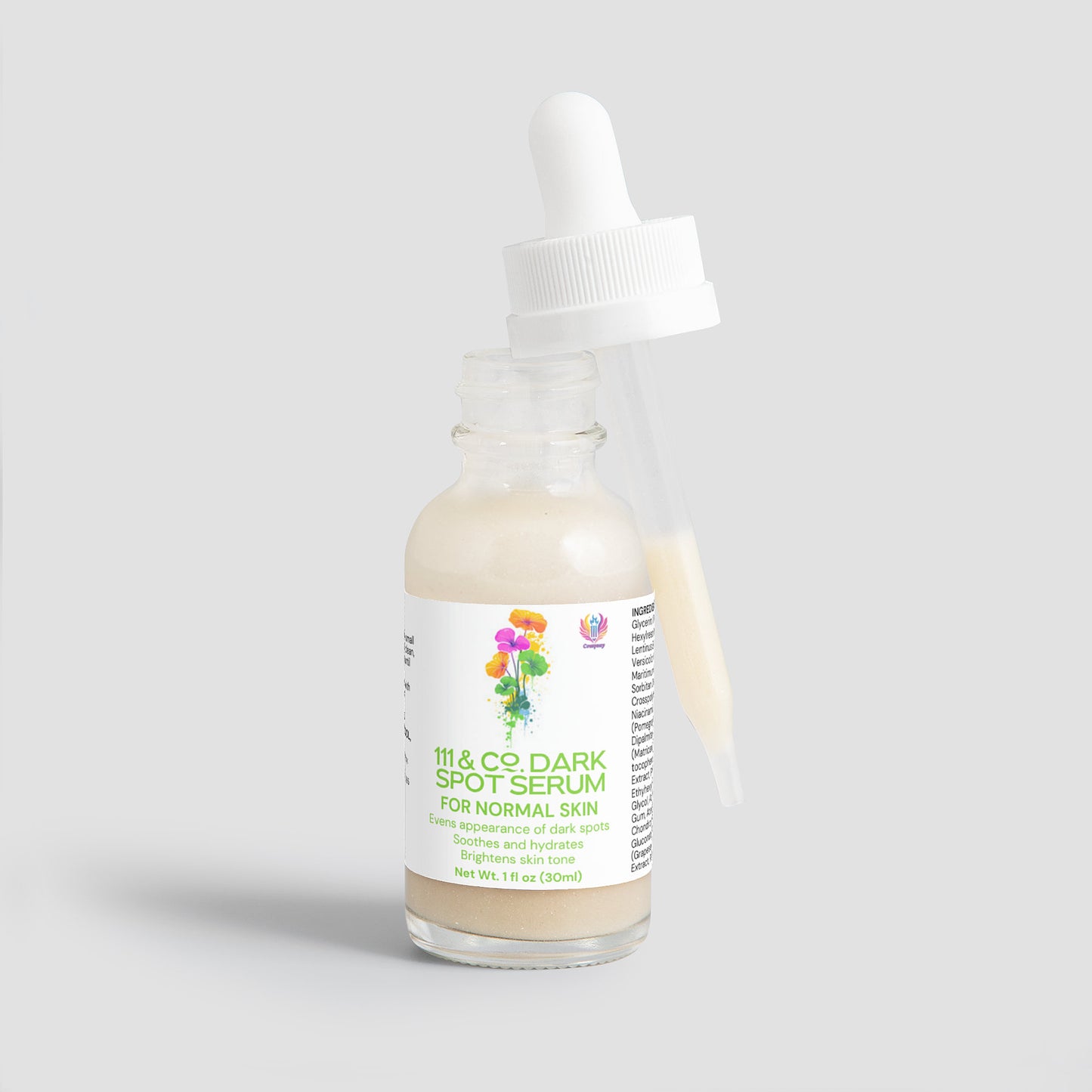 The frosted glass bottle labeled 111 & COMPANY DARK SPOT SERUM FOR NORMAL SKIN features a colorful floral design. An open bottle with a dropper against it sits on a light gray background, promising dark spot reduction and an even skin tone in just 1 fl oz (30 ml) of product.