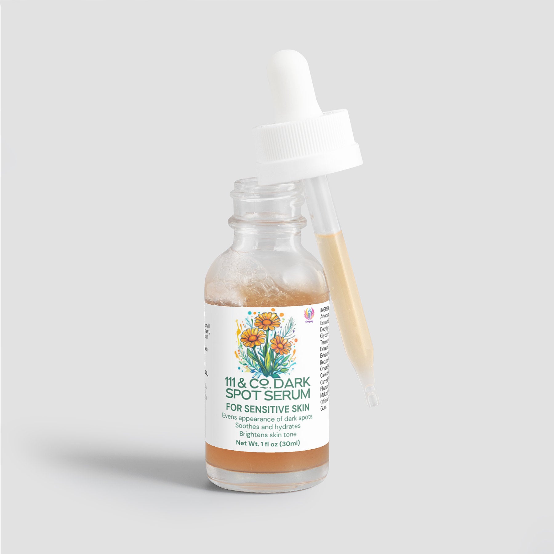 A glass dropper bottle displays 111 & Company Dark Spot Serum for Sensitive Skin with floral illustrations. The opened dropper, resting on the rim, holds a beige liquid. Made from natural ingredients, this 1 fl oz (30 ml) serum is crafted to even skin tone and brighten.