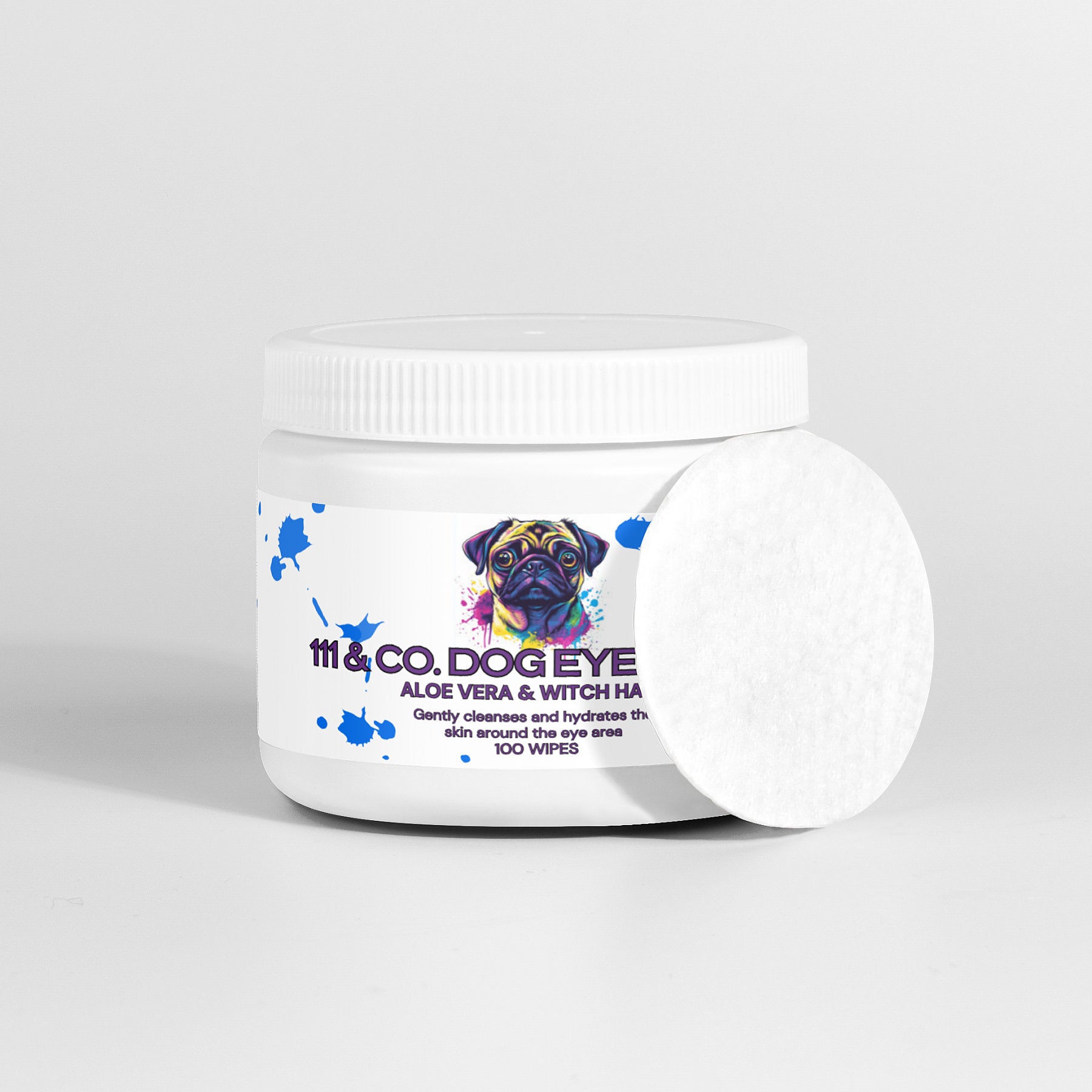 A white container of 111 & COMPANY DOG EYE WIPES with natural ingredients like aloe vera and witch hazel features a colorful dog illustration on the label, perfect for tear stain removal. The lid is white, and one round cotton wipe leans against the packaging, indicating 100 wipes.
