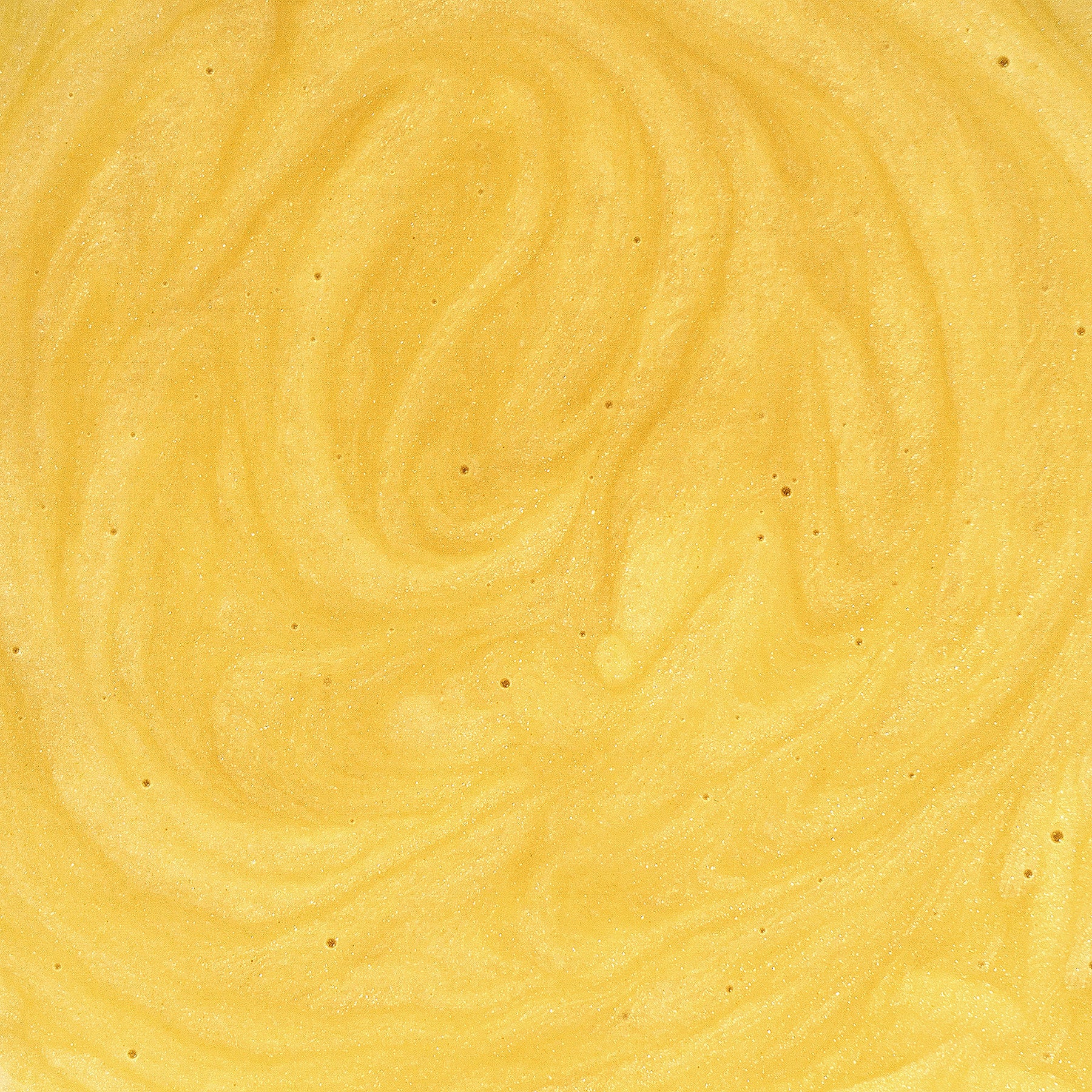 A close-up of 111 & Company Dog Skin Soothing Cream showcases its creamy, vibrant yellow texture with subtle swirls and fine air bubbles. The glossy sheen is enhanced by antioxidant-rich ingredients, giving it a luxurious cream appearance.