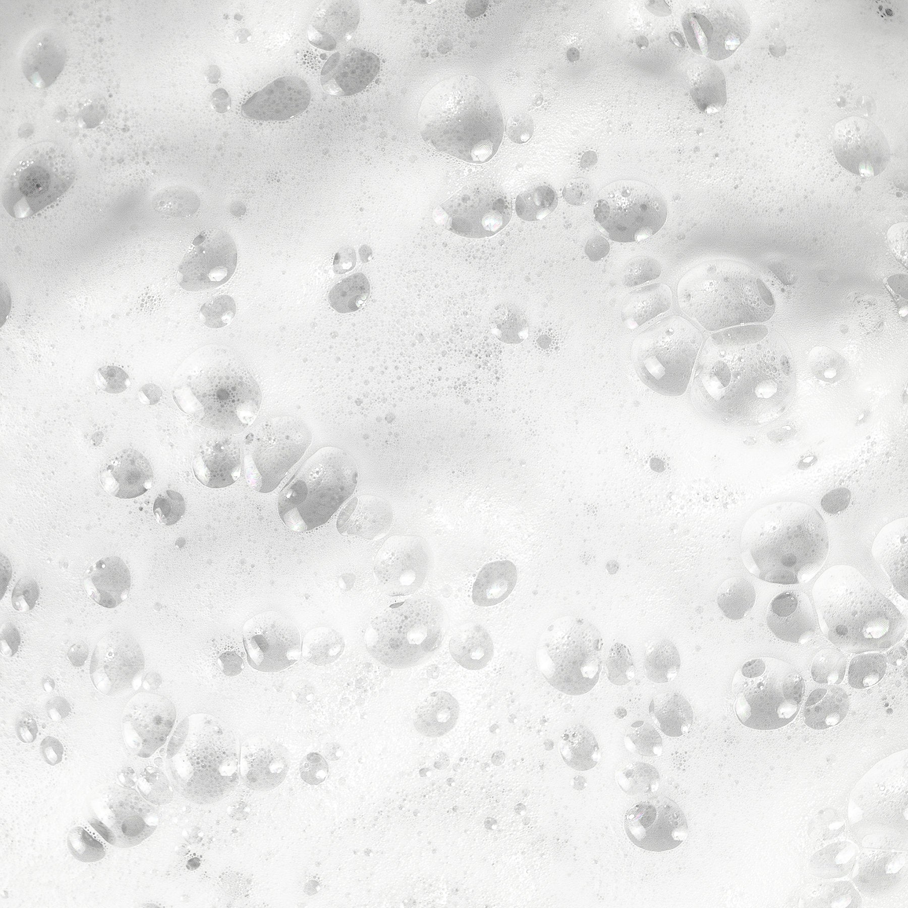 Close-up of white soap bubbles on the surface, reminiscent of 111 & COMPANY DOG WATERLESS SHAMPOO. Bubbles vary in size, some larger and defined, others smaller and diffuse. Light reflection enhances a shiny, wet appearance.