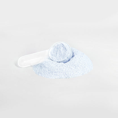 A white scoop partially filled with 111 & COMPANY ENERGY POWDER (COTTON CANDY), a light blue, sugar-free powder from 111 & Company, rests on a pile against a white background. The image features soft, muted colors and is centered to highlight the balanced energy offering.