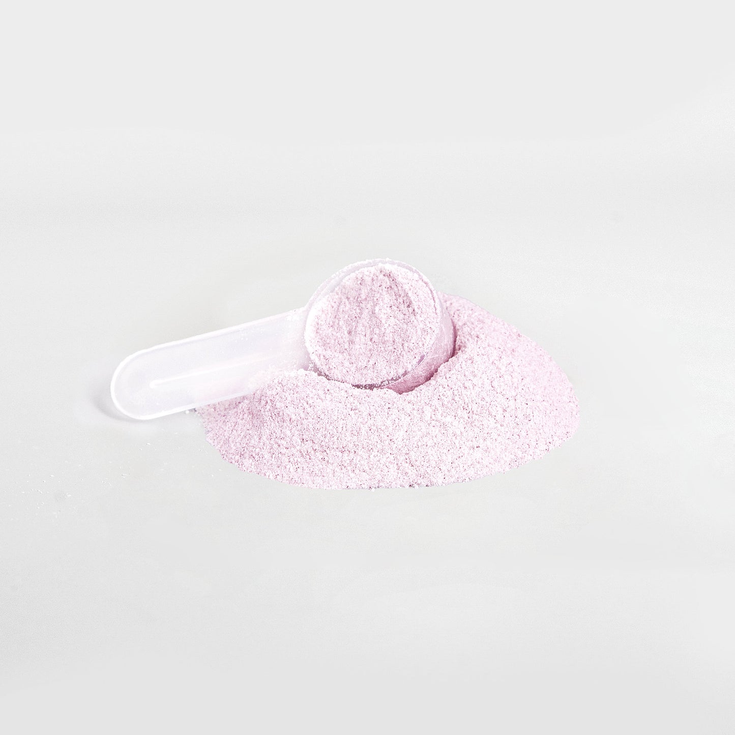 A scoop filled with 111 & COMPANY ENERGY POWDER (GUAVA BERRY) sits on a mound of the same fine, pale pink powder against a white background. Sugar-free and balanced for vitality, the tilted scoop is partially buried.