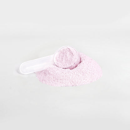 A scoop filled with 111 & COMPANY ENERGY POWDER (GUAVA BERRY) sits on a mound of the same fine, pale pink powder against a white background. Sugar-free and balanced for vitality, the tilted scoop is partially buried.