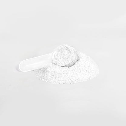 A white plastic scoop rests in a mound of 111 & COMPANY ENERGY POWDER (LYCHEE SPLASH) on a light gray background, filled with sugar-free powder for precise measuring and dispensing.