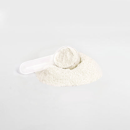 A plastic scoop partially buried in a heap of 111 & Company Energy Powder (Yuzu Flavor) on a plain white background, filled with fine, light powder, promising balanced energy in every measure.