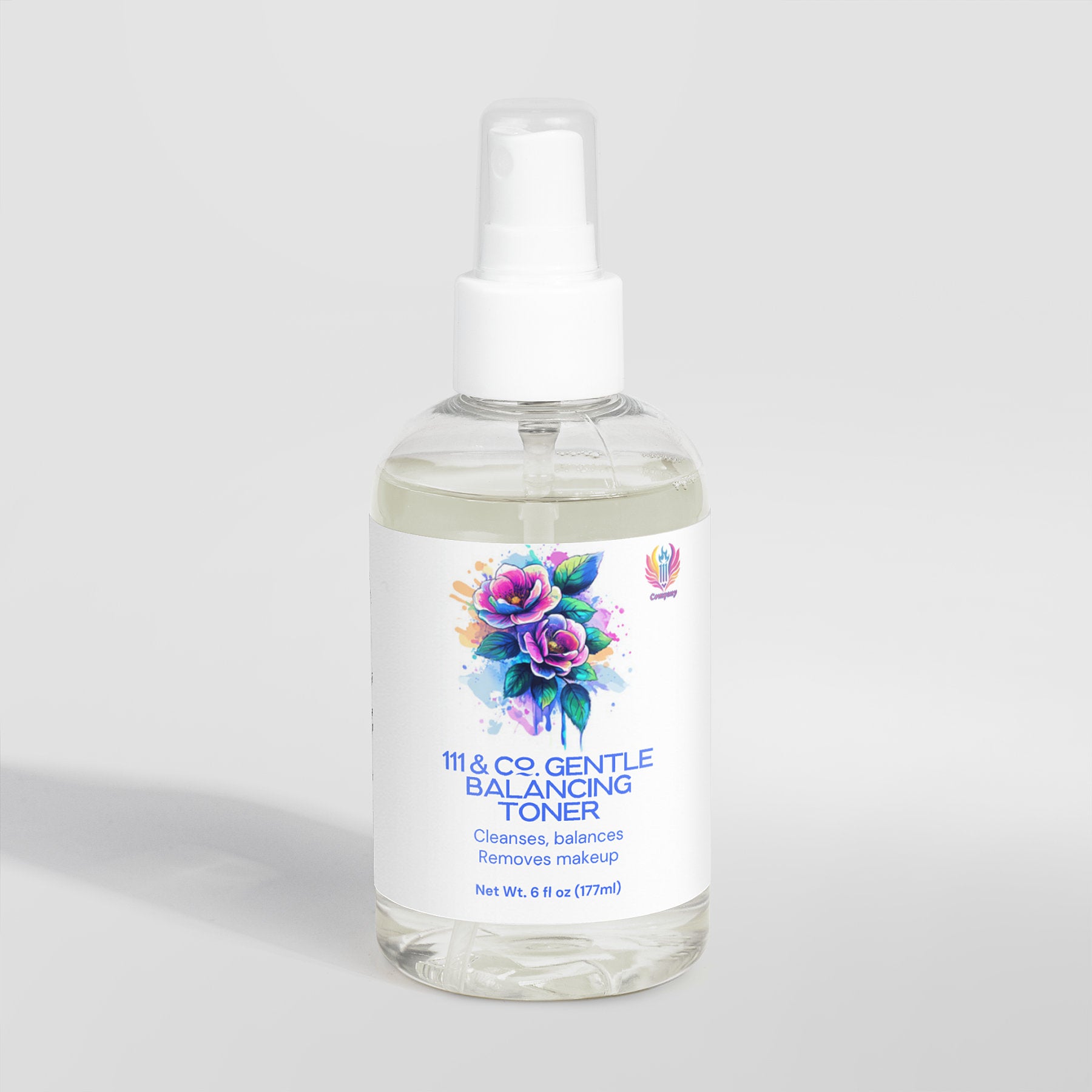 A clear spray bottle with a white label reads 111 & COMPANY GENTLE BALANCING TONER in blue. Adorned with watercolor flowers, it highlights green tea and promises cleansing, balancing, and makeup removal. Suitable for sensitive skin, the 6 fl oz (177 ml) bottle is set against a light gray backdrop.