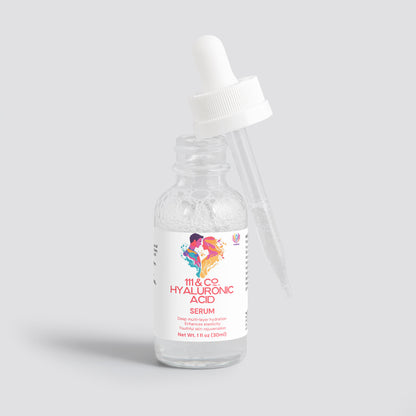 The clear glass bottle of 111 & Company Hyaluronic Acid Serum features a white label with colorful artwork. The dropper leans against it, displaying text promising Deep Hydration and Skin Rejuvenation for All Skin Types on a light gray background and Net Wt. 1 fl oz (30ml).