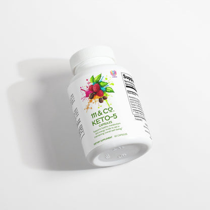 A white bottle of 111 & COMPANY KETO-5 capsules lies on a white surface. The label features vibrant images of berries and leaves, promoting its support for ketosis and fat burning. Nutritional information is partially visible on the side.