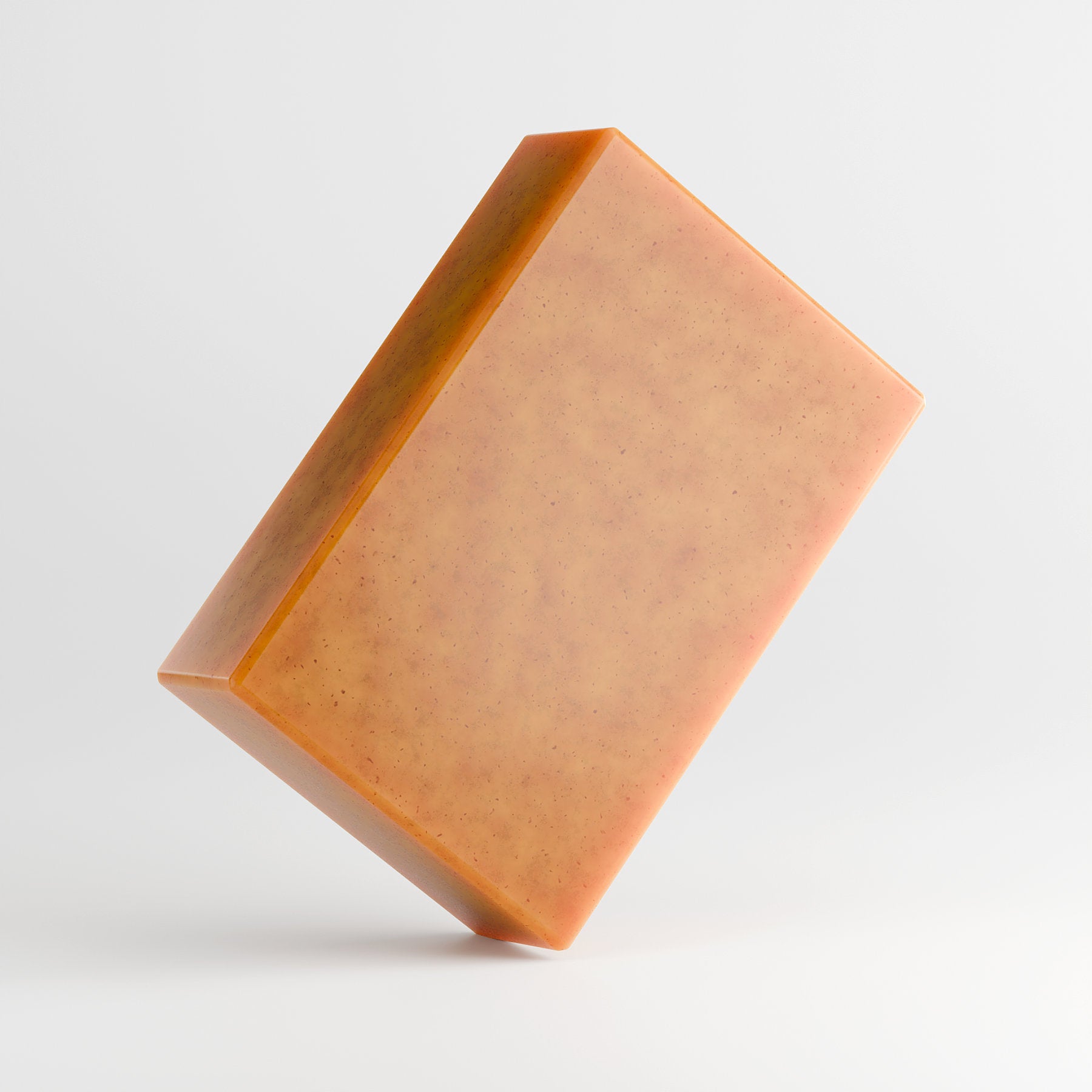 The 111 & COMPANY KOJIC ACID & TURMERIC SOAP by 111 & Company is a caramel-hued, rectangular bar with tiny dark speckles. Angled against a light gray background, it features smooth surfaces and sharp edges, offering a brightening formula for a radiant glow.